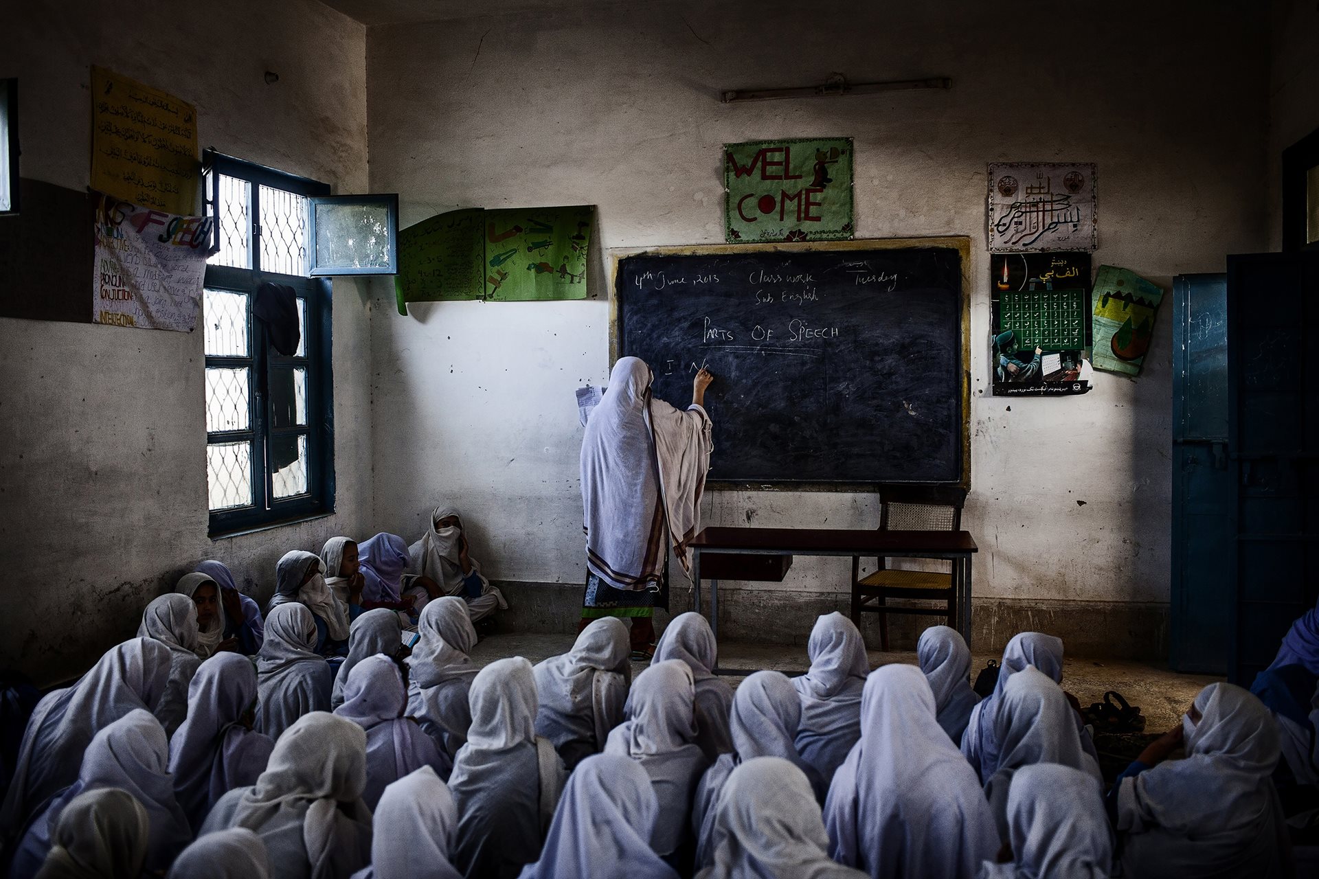 A row of burqas hangs in a vendor&rsquo;s shop in a country where the Taliban has banned girls from secondary and higher education. Kabul, Afghanistan.