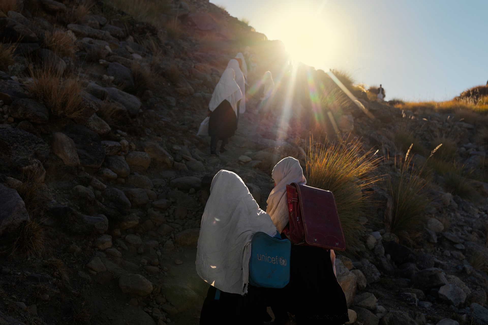 Students walk to Miadad Primary School in Khartanai Village, Haska Meyna District, Afghanistan. Hundreds of children across the country travel long distances on foot to attend classes.&nbsp;