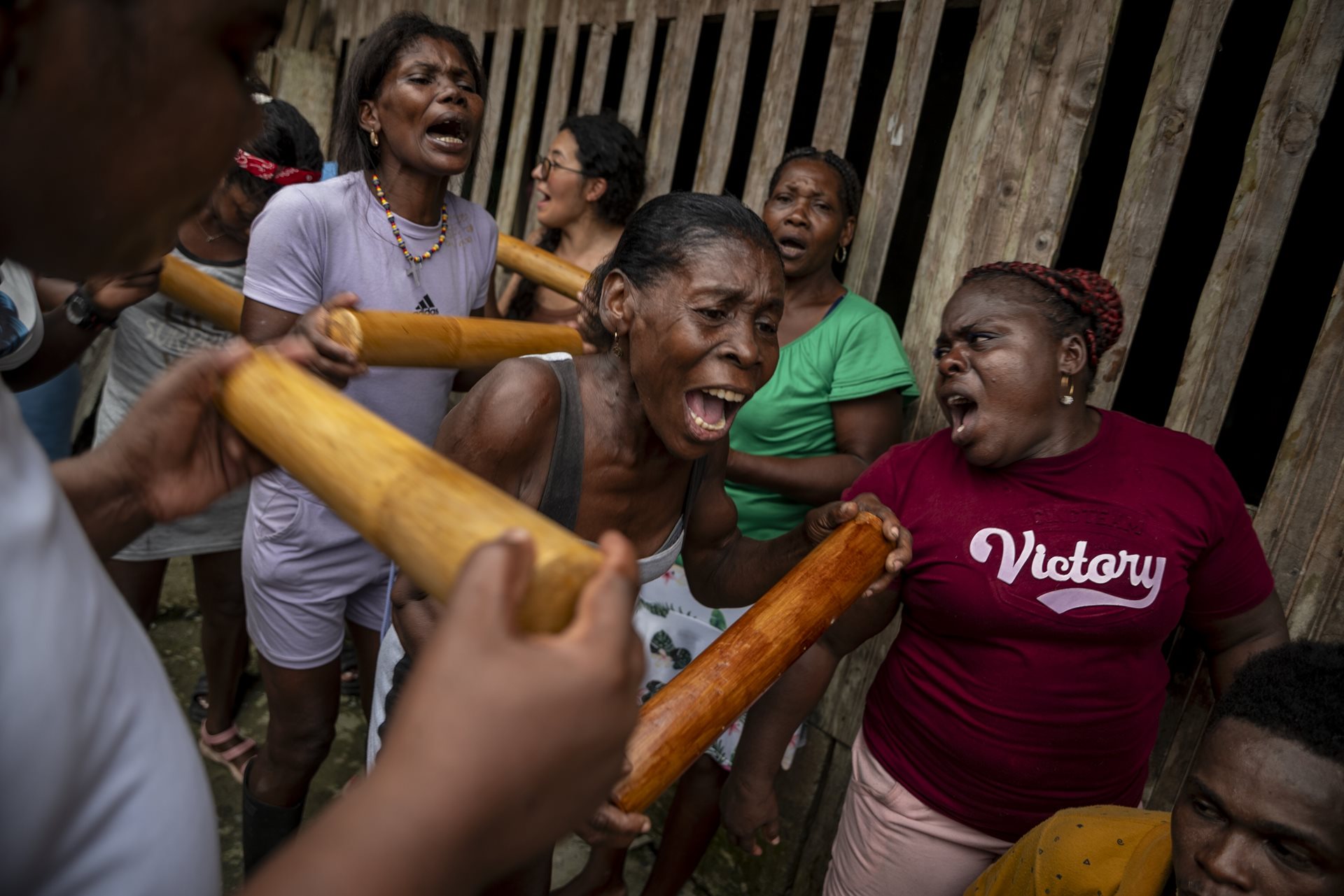 Mercedita and others sing traditional songs during a house-to-house tour in Juntas, Buenaventura, Colombia. Her singing plays an important ritual role, creating a mystical trance that invokes ancestral presences.&nbsp;