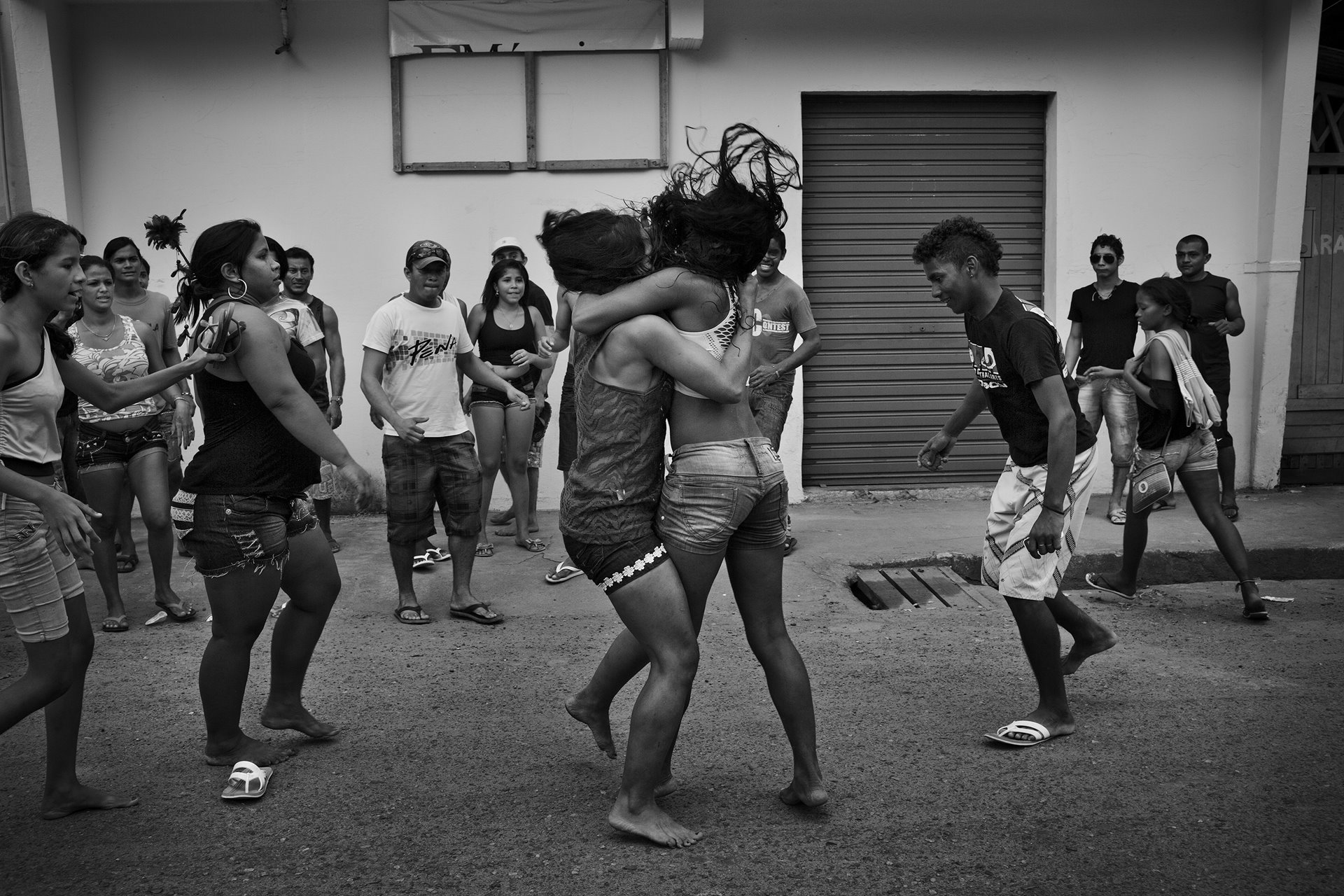 A fight breaks out between two women after a party in the Xingu river bank in Altamira, in Pará, in the Brazilian Amazon. Construction work on the Belo Monte Dam generated a surge of migrant labor to the region. The population of Altamira grew from 100,000 to more than 150,000 in just two years, the vast majority of the increase being single men. Violence increased in the town, which faced a serious housing deficit and inadequate sanitation, as well as social issues such as prostitution.&nbsp;
