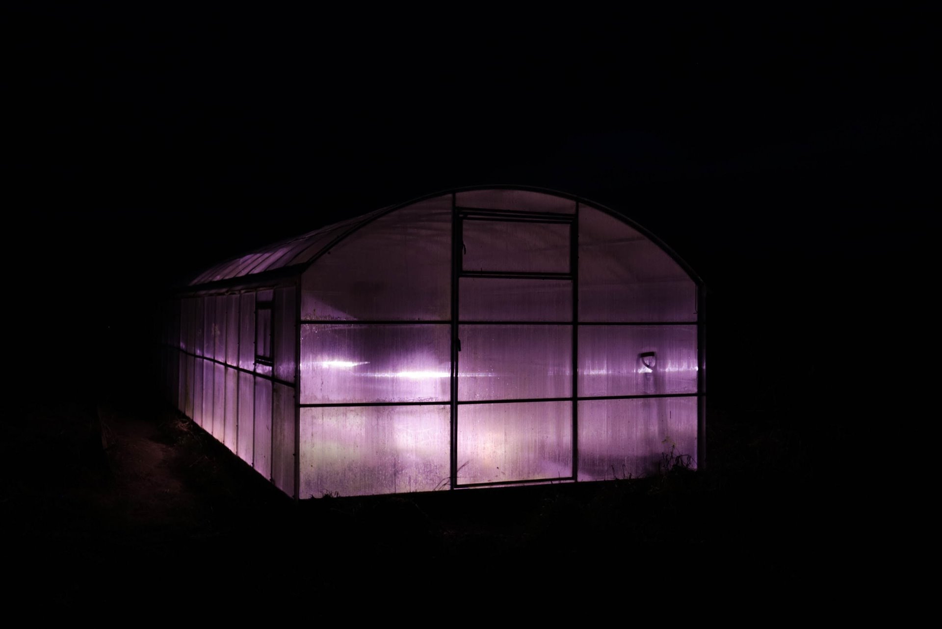 Light shines from the Svetlana village greenhouse late at night. Villagers in Svetlana grow their own vegetables.