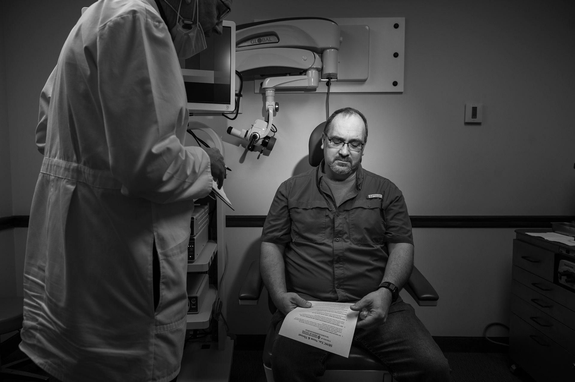 Firefighter Casey McEwen, who battled the East Palestine derailment fire for five hours without hazmat gear, sees an ear, nose, and throat specialist for his post-derailment symptoms. He worries about possible long-term effects like cancer that could impact his ability to provide for his wife and his five adopted children. Columbiana, Ohio, United States.