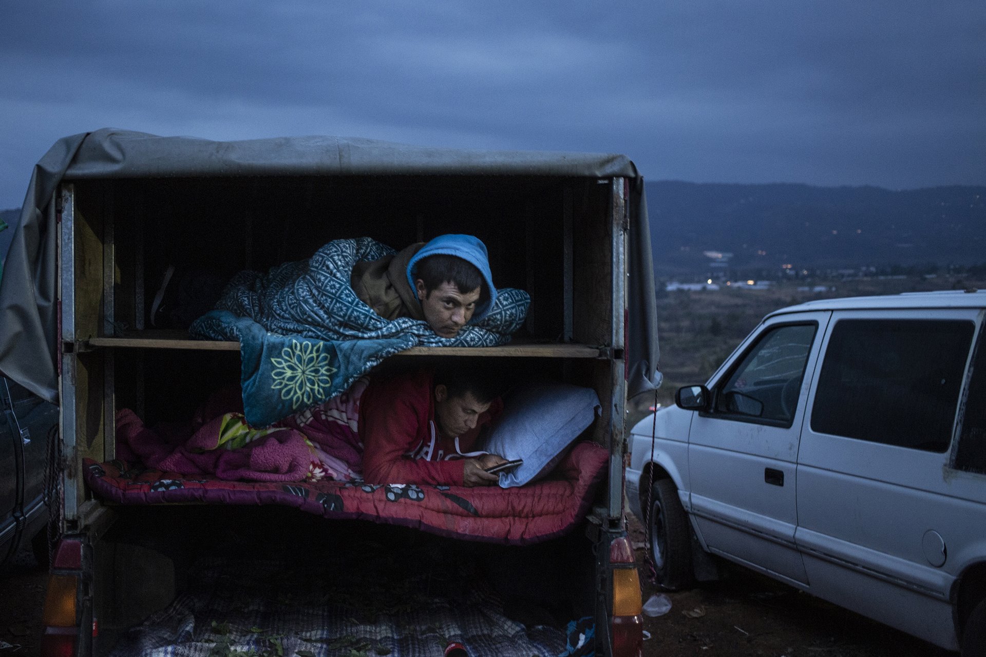 Workers rest inside a truck that has transported flowers to Central de Abasto wholesale market, known as &ldquo;La Finca&rdquo;, in Villa Guerrero, Mexico. As activity begins at dawn, many workers sleep in their trucks once sales are over, which means they inhale any residue of chemicals sprayed onto the flowers.