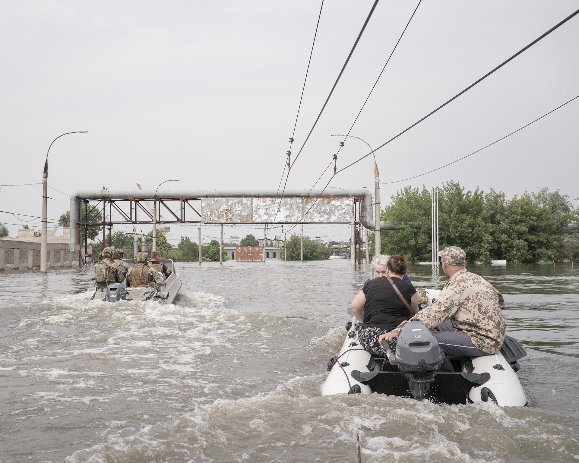 Volunteers Viktor, Oleksandr and fellow volunteers help evacuate Maria and her daughter Svitlana from their home on Korabel, an island that forms part of Kherson city, and was the area most affected by the floods.&nbsp;