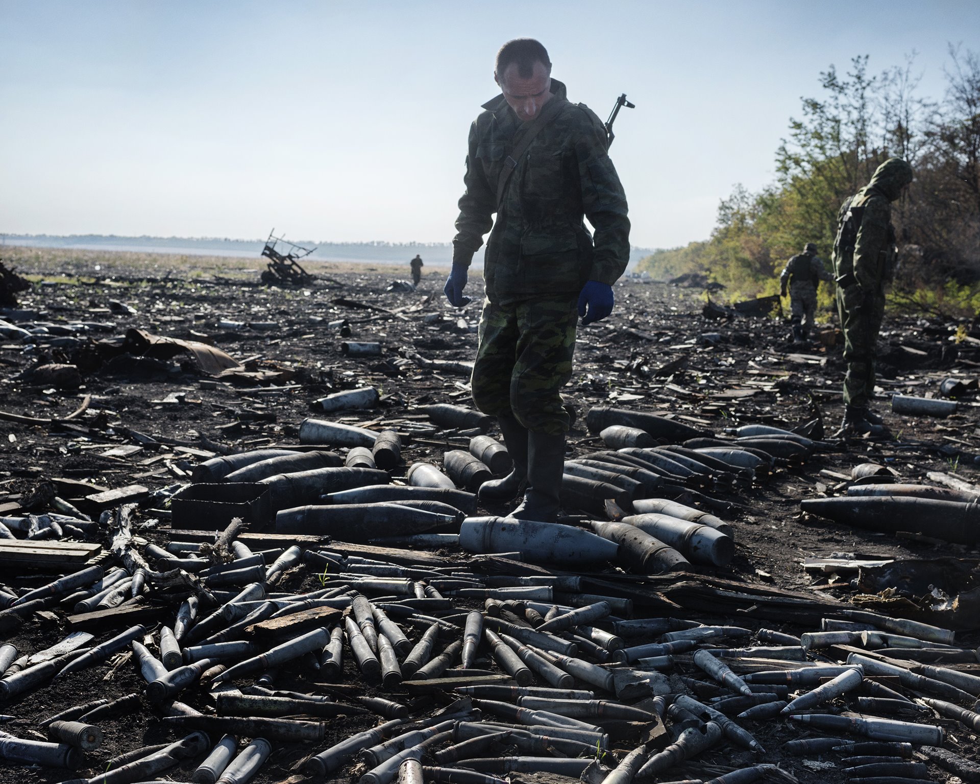DNR fighters search a battlefield for any live ammunition left behind by Ukrainian troops after August clashes with separatists, in Amvrosiivka, Donbas, Ukraine.