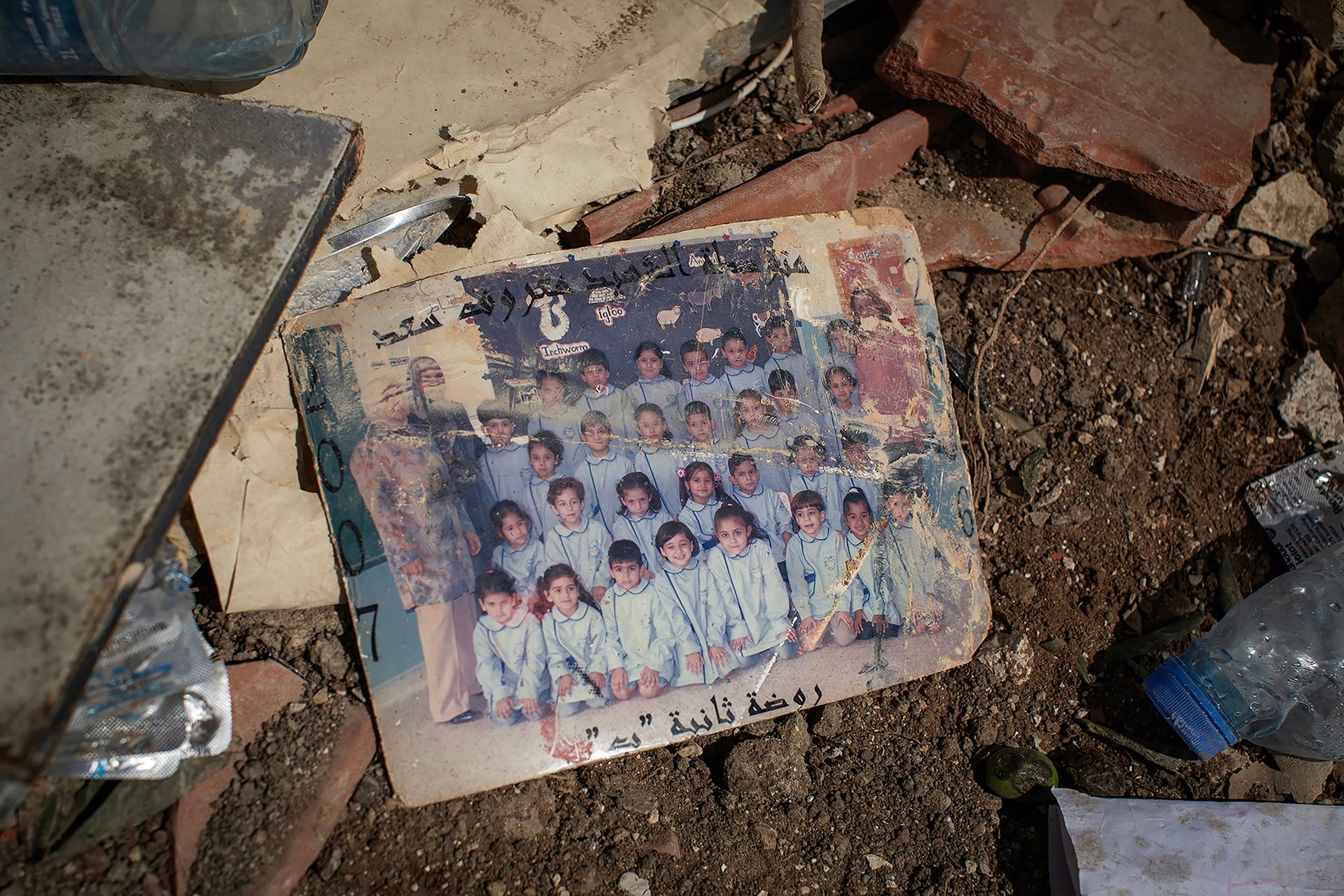 Photographs scattered on the floor of a home in Ain el-Delb, Lebanon, following an Israeli airstrike on 29 September 2024 that killed at least 45 people.