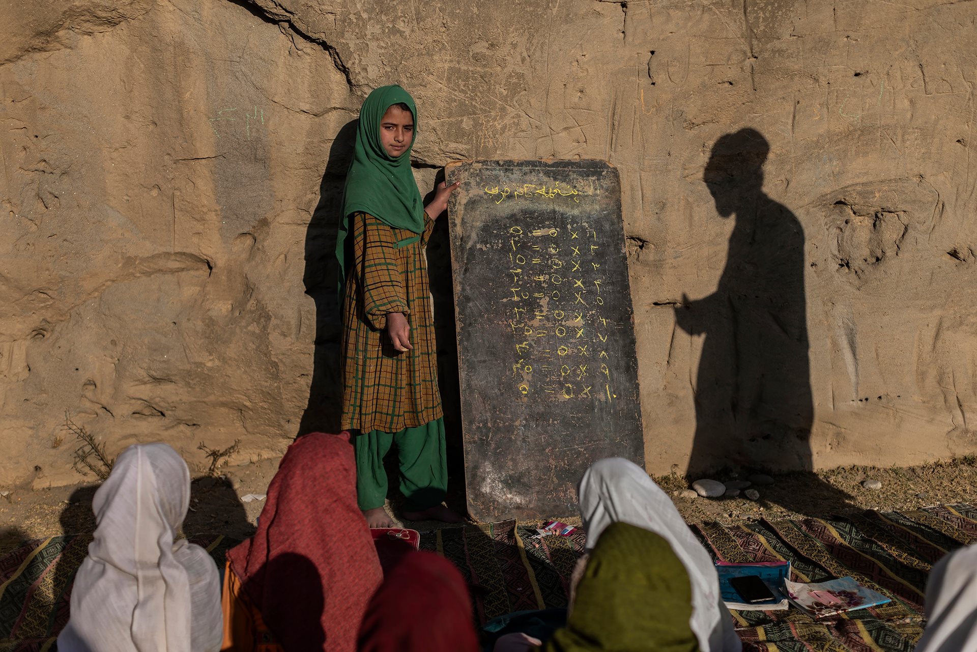 Marjah (10) attends a lesson at an open-air primary school in Maidan Wardak Province, Afghanistan. &ldquo;I want to become a doctor,&rdquo; she says. Decades of war and destroyed infrastructure have left many schools across the country without buildings or basic resources.