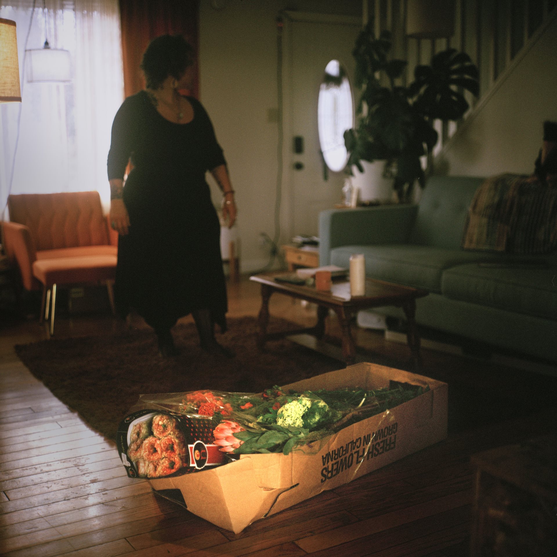 A death doula, an end-of-life companion, prepares for a guest&#39;s death with flowers. The service is free of charge because the experience is grounded in community care, not profit. Washington State, United States.