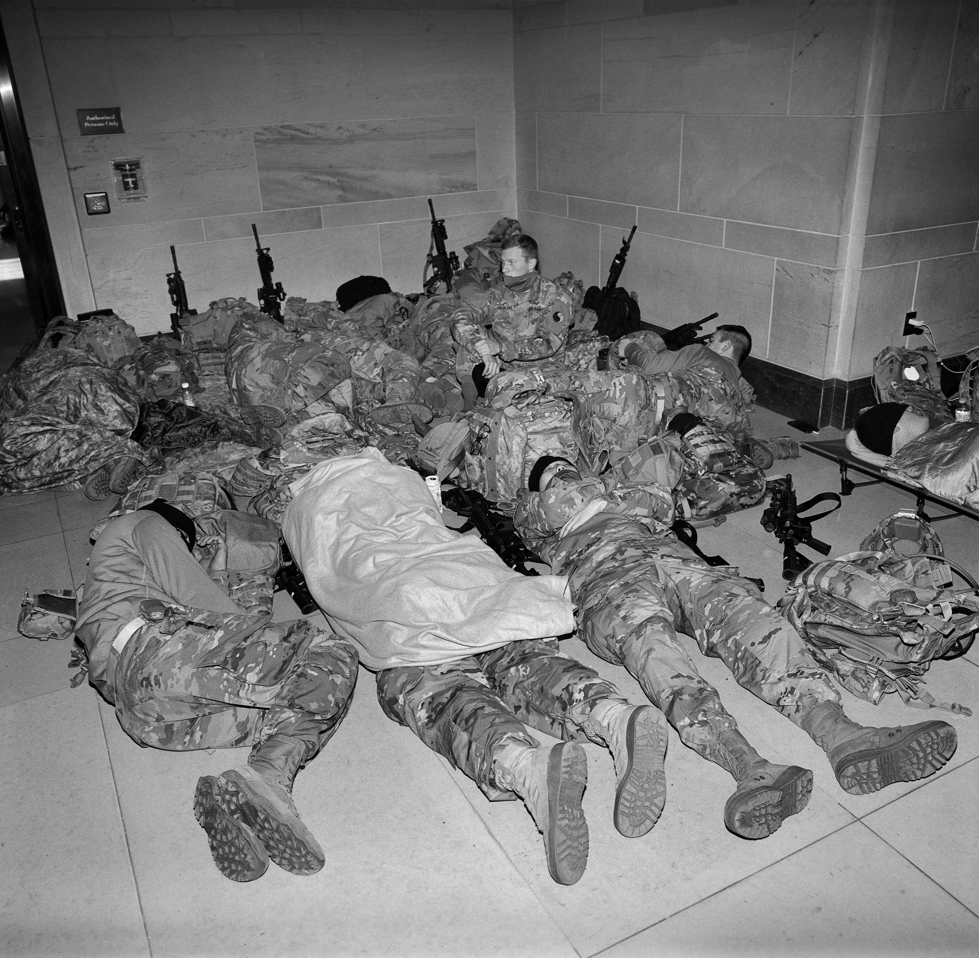 National Guard soldiers rest inside the Capitol Building, Washington DC, USA, on 7 January 2021. The troops were called on following the 6 January invasion of the Capitol Building to protect lawmakers and the complex from further attack, and remained deployed until 24 May.