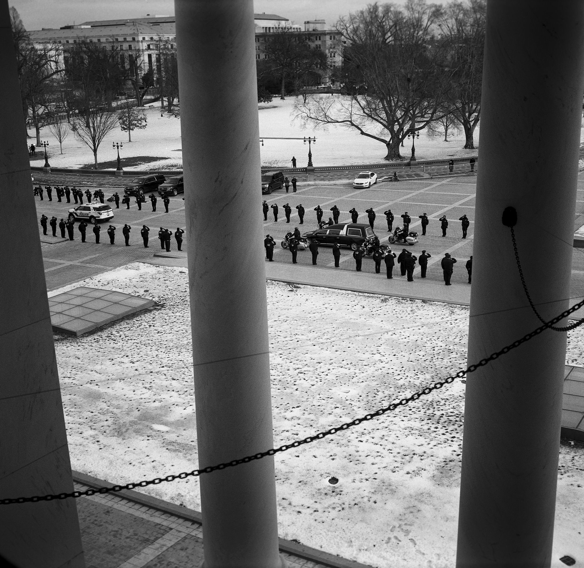 The remains of US Capitol Police Officer Brian Sicknick depart in a motorcade past a line of fellow police officers along the East Front, after lying in honor in the Capitol Building. Officer Sicknick died of a stroke after defending the building against pro-Trump protesters on 6 January.