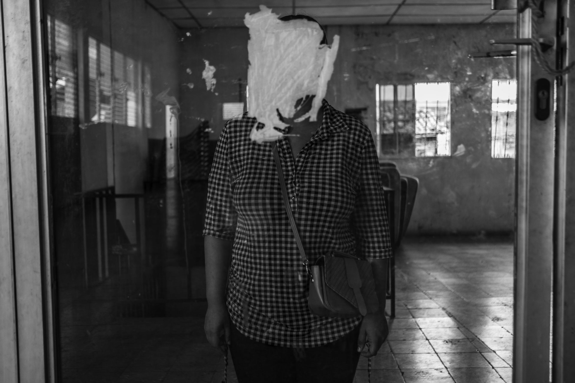 Alba (28) was living with her parents and getting ready to travel to the United States on a work visa program when she was arrested by National Civil Police without evidence or a warrant. In prison, she was abused and tortured, witnessing death and miscarriages among the other inmates. San Salvador, El Salvador.