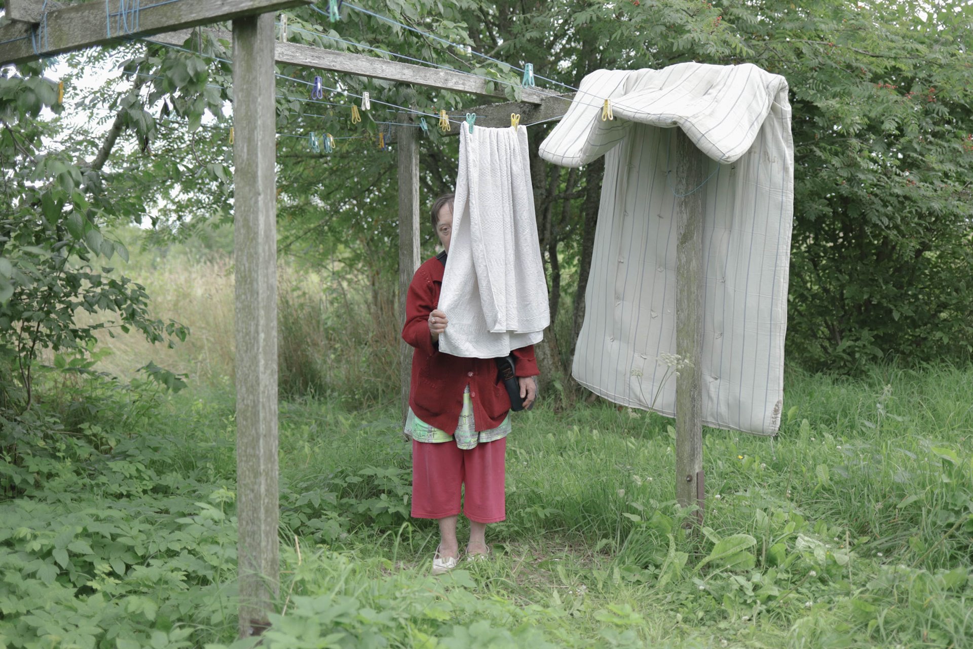 Tatyana hides behind a towel while on a walk.