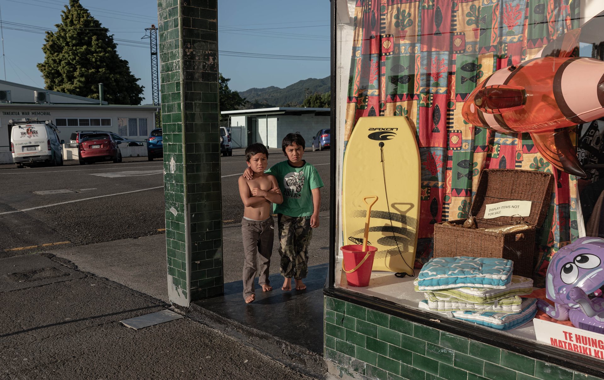 Two boys look into the window of a second-hand shop in Tāneatua, New Zealand, a settlement ​known as &lsquo;The Gateway to Tūhoe&rsquo;.