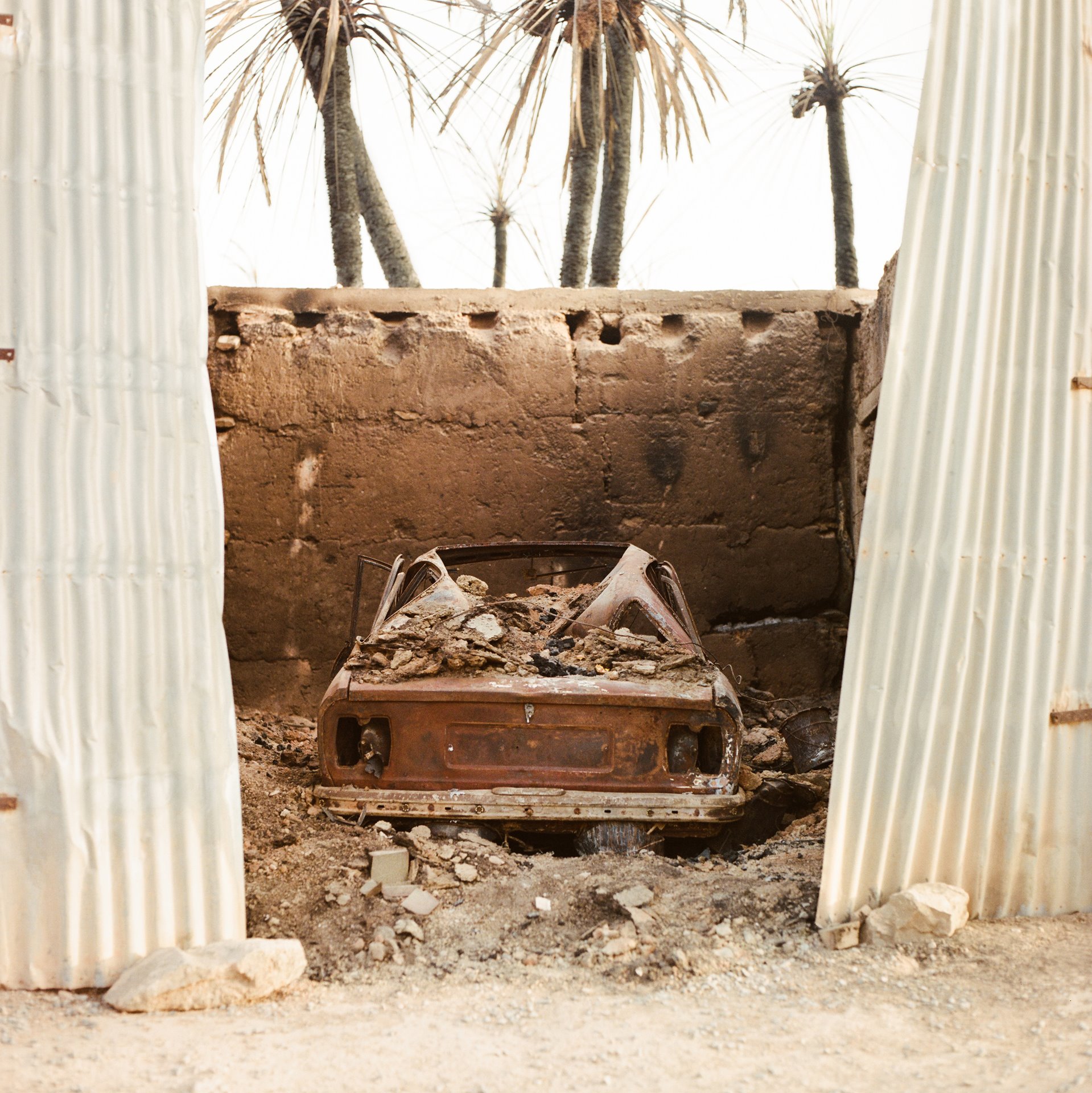 The remains of a car stand in a burnt-out house in Tighmert Oasis, in southern Morocco. A few weeks earlier, fire had burned several houses, hundreds of date palms and vegetable gardens, and killed around 400 cattle. The blaze burned from midday until around 8pm, and was one of many suffered in the region in August 2020.&nbsp;