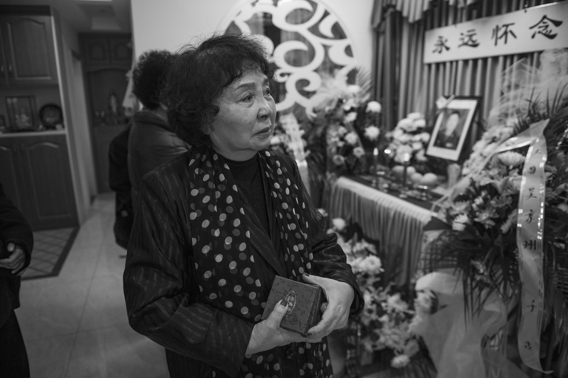 Sheng Hailin is emotional before her husband&rsquo;s memorial altar. Wu Jingzhou passed away on December 4, leaving Sheng Hailin to navigate the remainder of her daughters' upbringing alone. Hefei, Anhui Province, China.