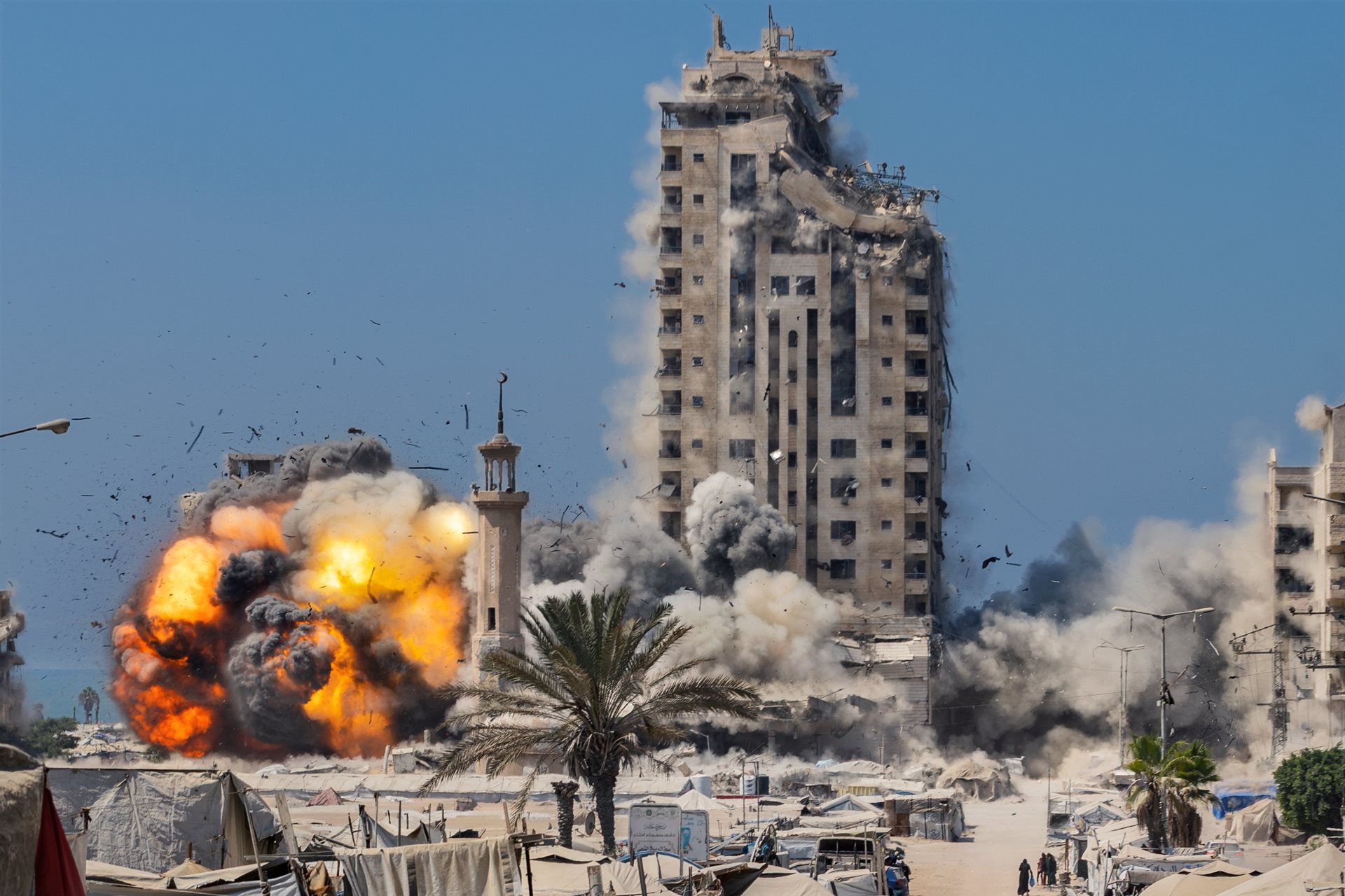 The Mushtaha Tower collapses in a military strike, amid hundreds of makeshift tents sheltering displaced Palestinians, as Israel&rsquo;s offensive on Gaza City intensified. Gaza Strip.