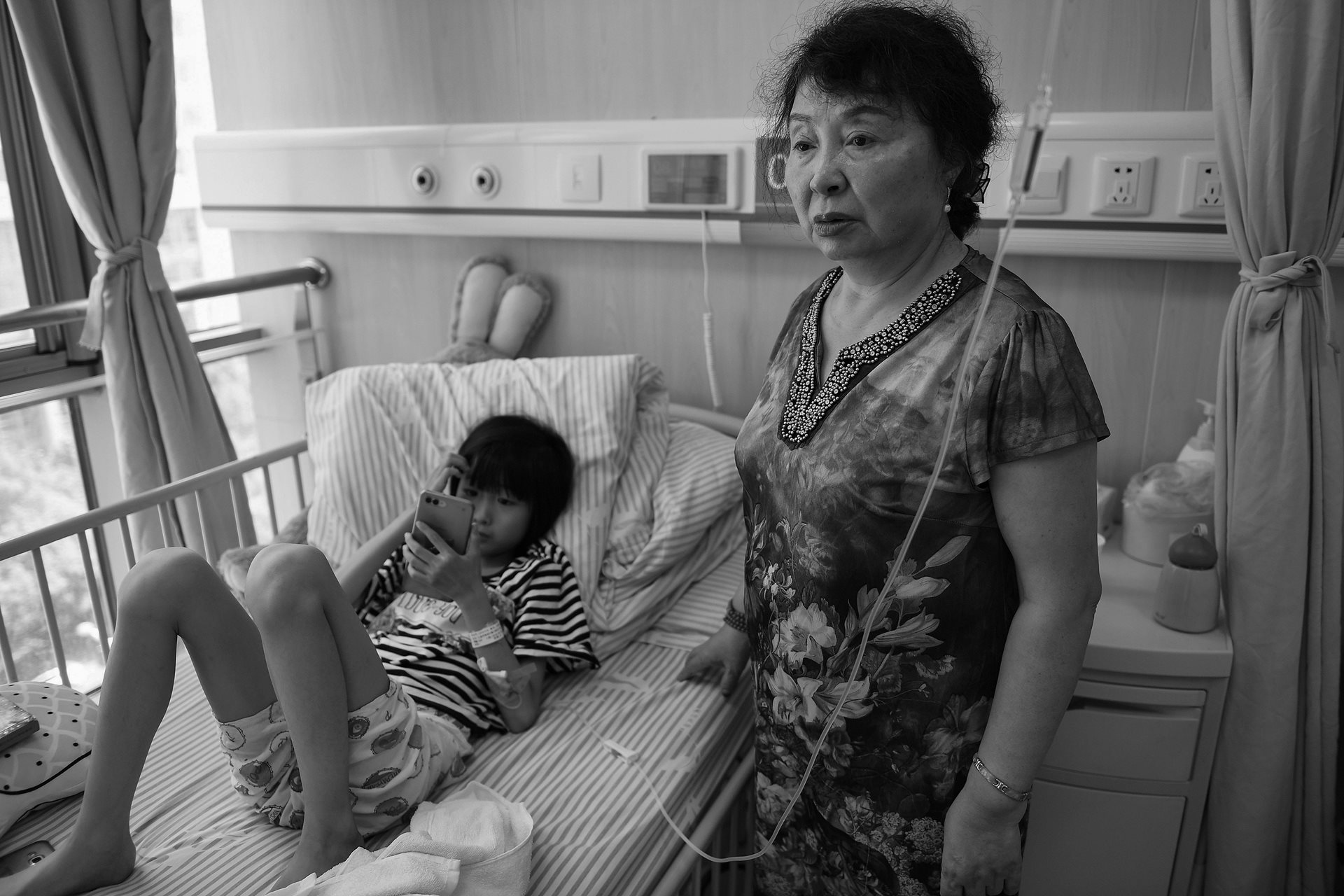 A worried Sheng Hailin watches over her daughter Huihui during a hospital stay in Hefei, Anhui Province, China.&nbsp;