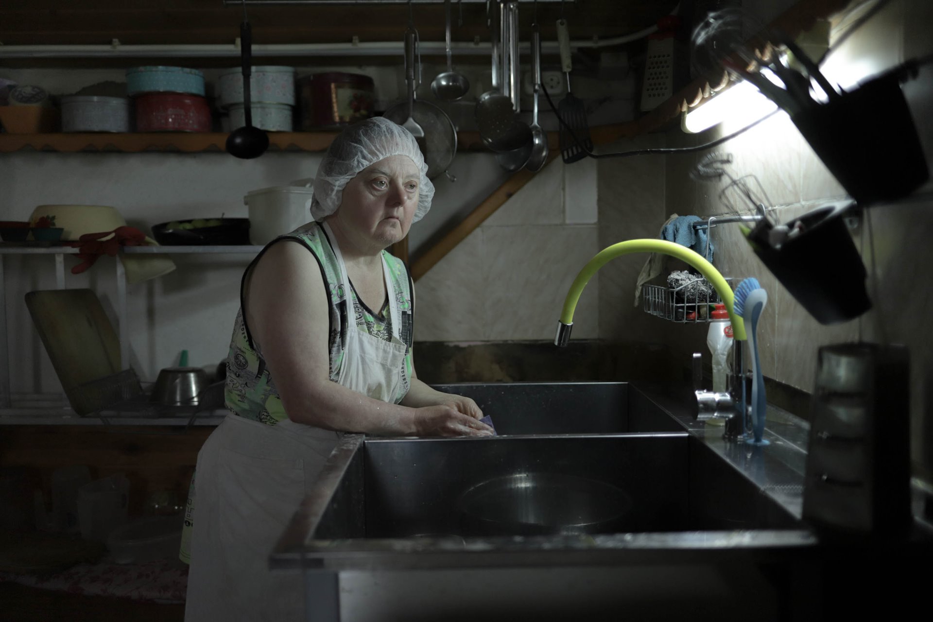 Tatyana washes the dishes after baking bread together with other residents of Svetlana.