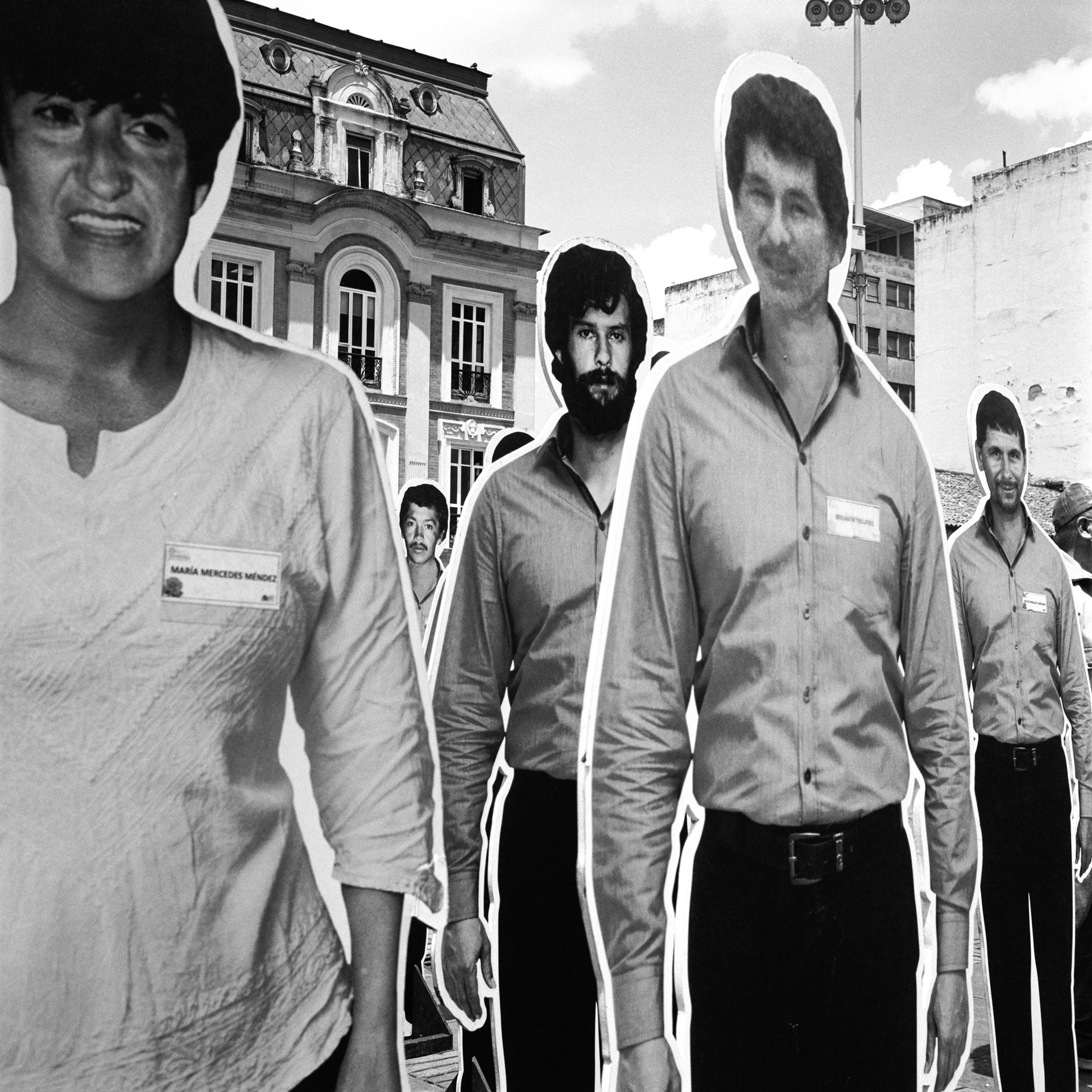 Photographic cutouts of disappeared members of the Patriotic Union (UP), a leftist political party founded by members of the Revolutionary Armed Forces of Colombia (FARC) and the Colombian Communist Party, stand in the Plaza de Bolívar in Bogotá, Colombia. During the 1980s, the party&rsquo;s leadership and members were subject to violent attack and assassinations, seemingly carried out with political motives by drug lords, paramilitary groups, and some members of the government&#39;s armed forces. Well over 5,000 people were killed, in what is now widely considered to be a case of genocide. While some investigations were opened and some perpetrators convicted, most of the murders were never solved.