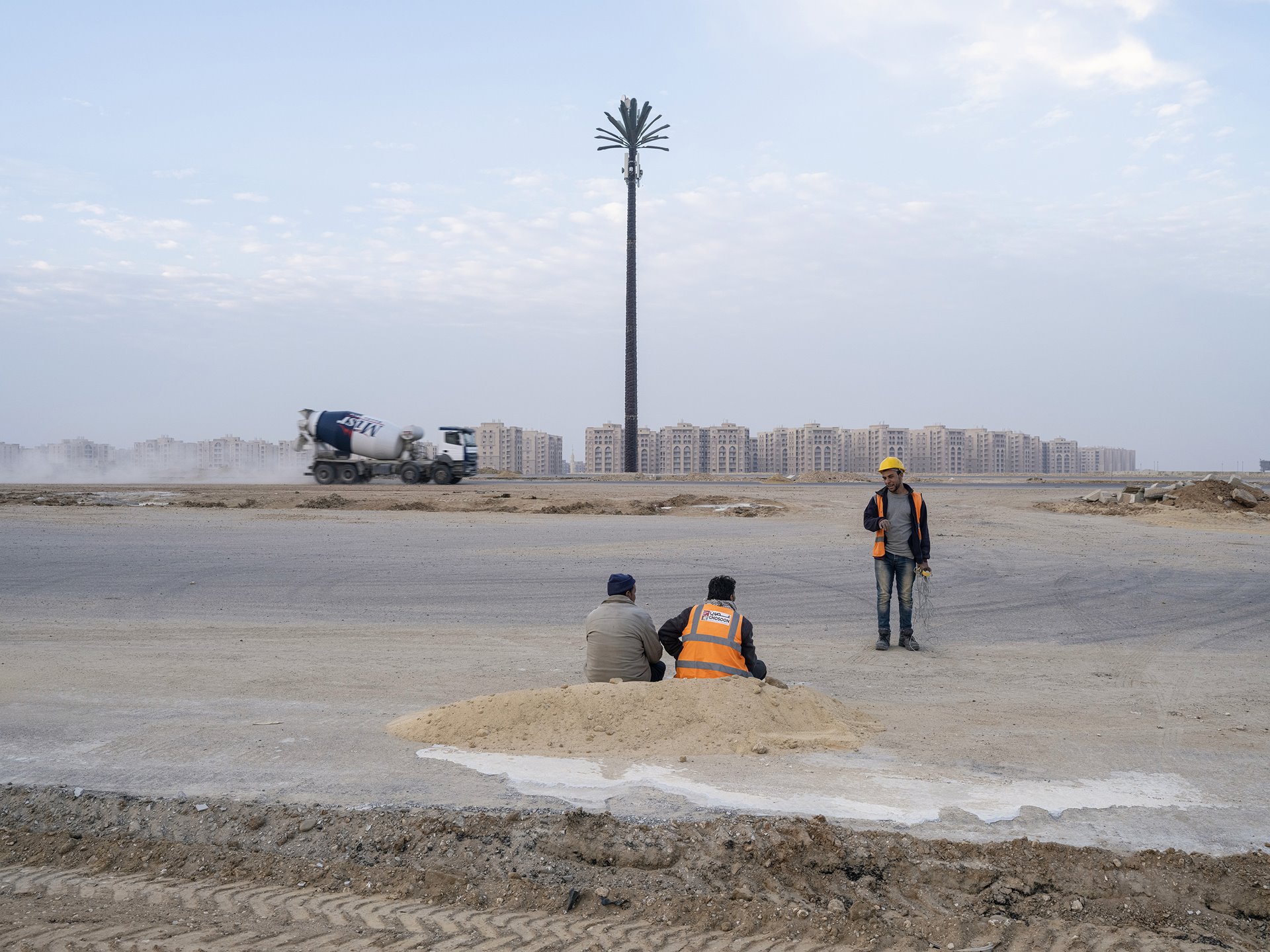 A mobile phone network antenna disguised as a palm tree rises in front of the Second Residential Neighbourhood (R2), north of Capital Park, in Egypt&#39;s New Administrative Capital, under construction near Cairo.