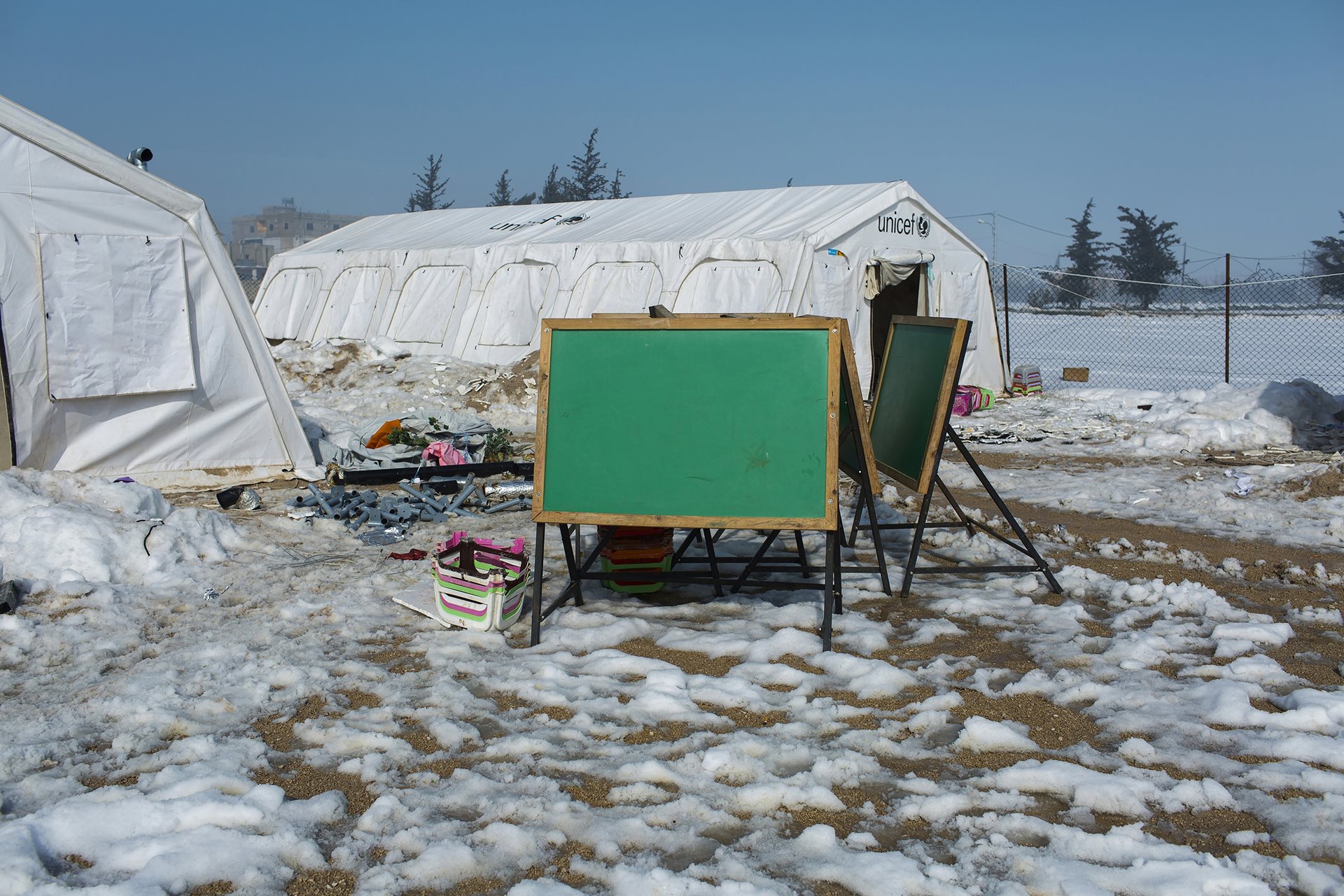 A chalkboard surrounded by snow outside a school for Syrian refugees. Freezing temperatures and lack of secure shelter pose serious health risks for refugees across the region. Zahle, Lebanon.