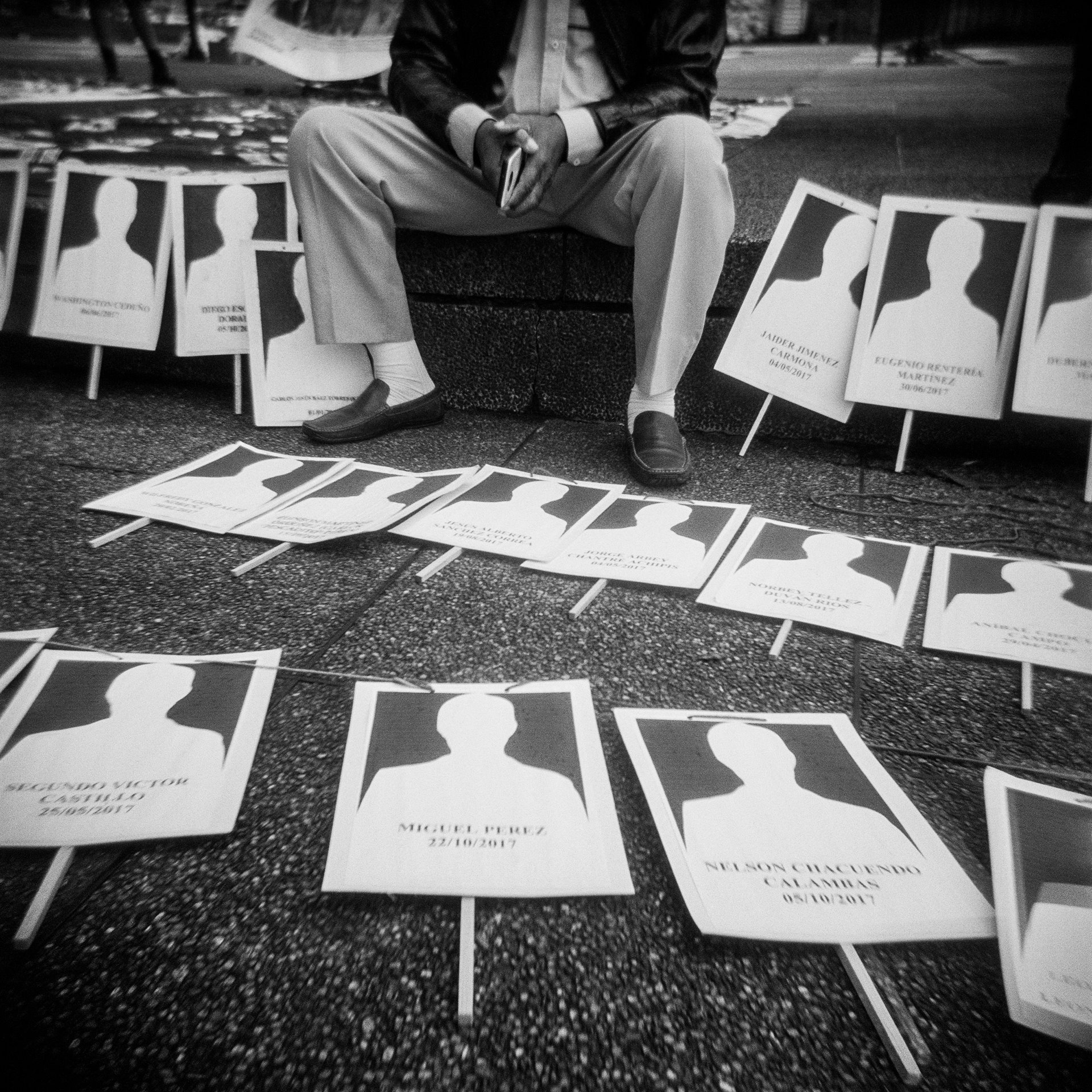 Members of the National Movement of Victims of State Crimes (MOVICE) protest in front of the Prosecutor&#39;s Office in Bogotá, Colombia. The protest was organized in response to an increase in the number of murders and disappearances of social leaders and human rights activists, as well as of former Revolutionary Armed Forces of Colombia (FARC) combatants demobilized after the 2016 peace agreement with the Colombian government. Hundreds of former FARC combatants had been killed since the agreement, and the United Nations Office for Human Rights in Colombia had also received information about the assassination of 120 human rights defenders.