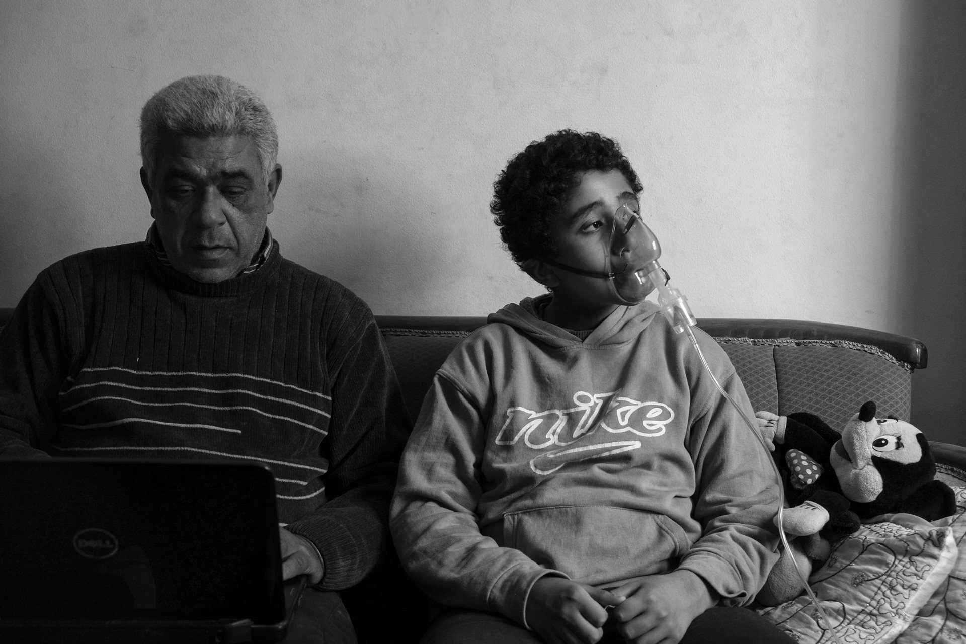 Ahmed (11), photographed with his father Saeed, was born with asthma and uses a ventilator three times a day. He plays goalkeeper in football as it requires less physical strain. Moon Valley, Alexandria, Egypt.