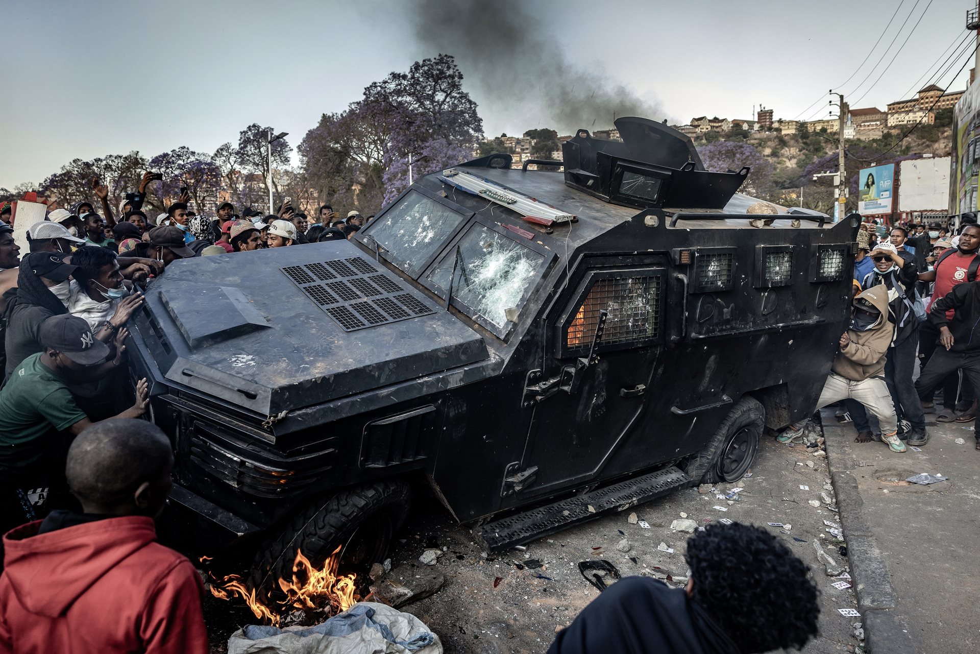 Protesters vandalize a Gendarmerie armoured vehicle as members of the CAPSAT military unit take control of the area around Lake Anosy, Antananarivo, Madagascar during clashes between demonstrators and security forces.&nbsp;