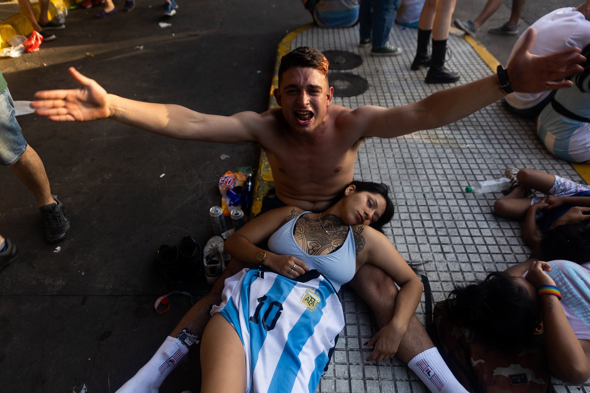 A man continues celebrating Argentina&rsquo;s victory at the 2022 FIFA World Cup as his friend takes a break, in Buenos Aires, Argentina.&nbsp;<b> </b>
