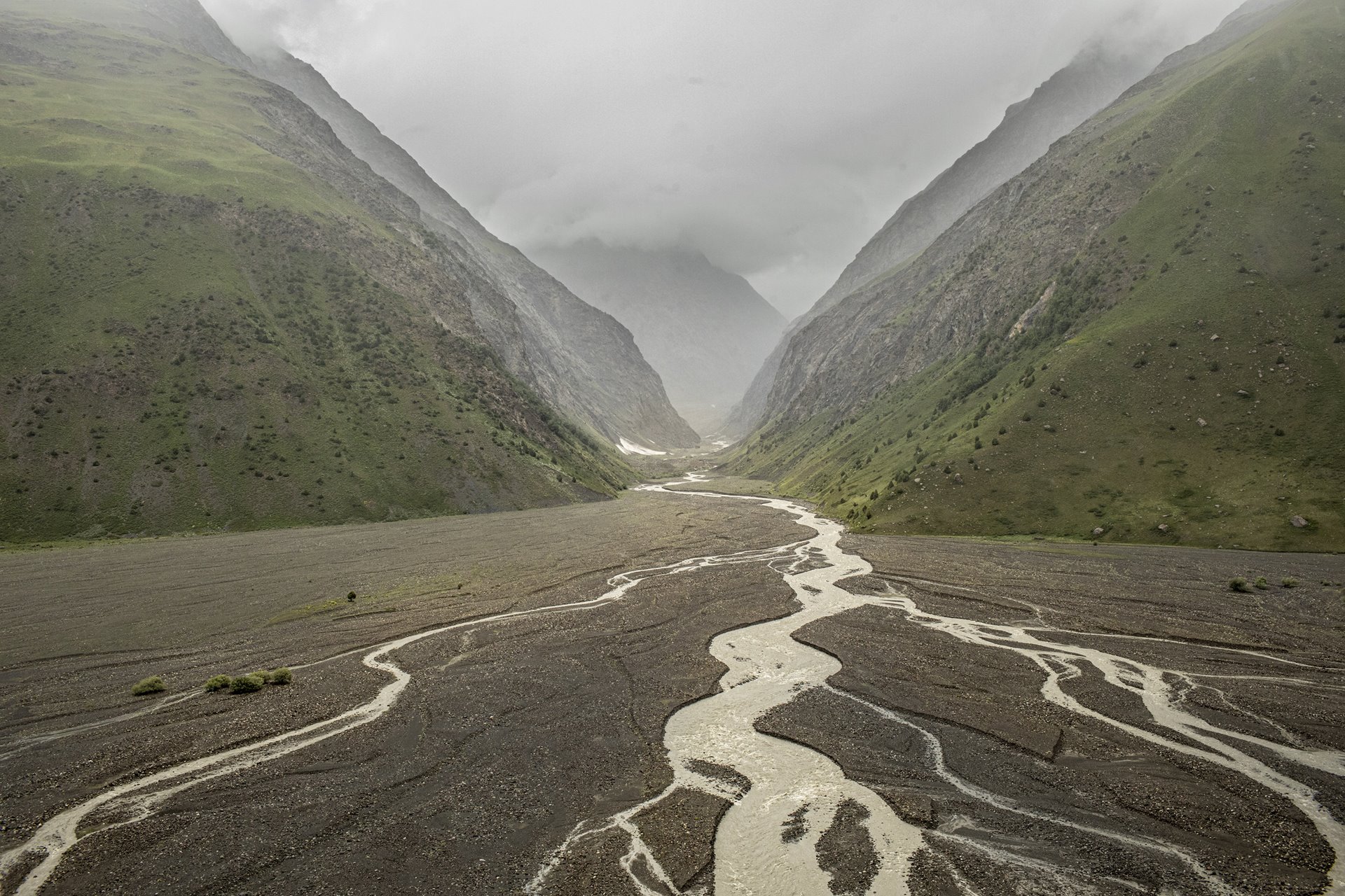 Vegetation grows in the riverbed of the Zeravshan River, in Tajikistan. The glacier feeding the river has retreated nearly a kilometer in the last 20 years. The Zeravshan is a former tributary of the Amu Darya River, but its water no longer reaches the Amu Darya as it is diverted through canals in Uzbekistan.