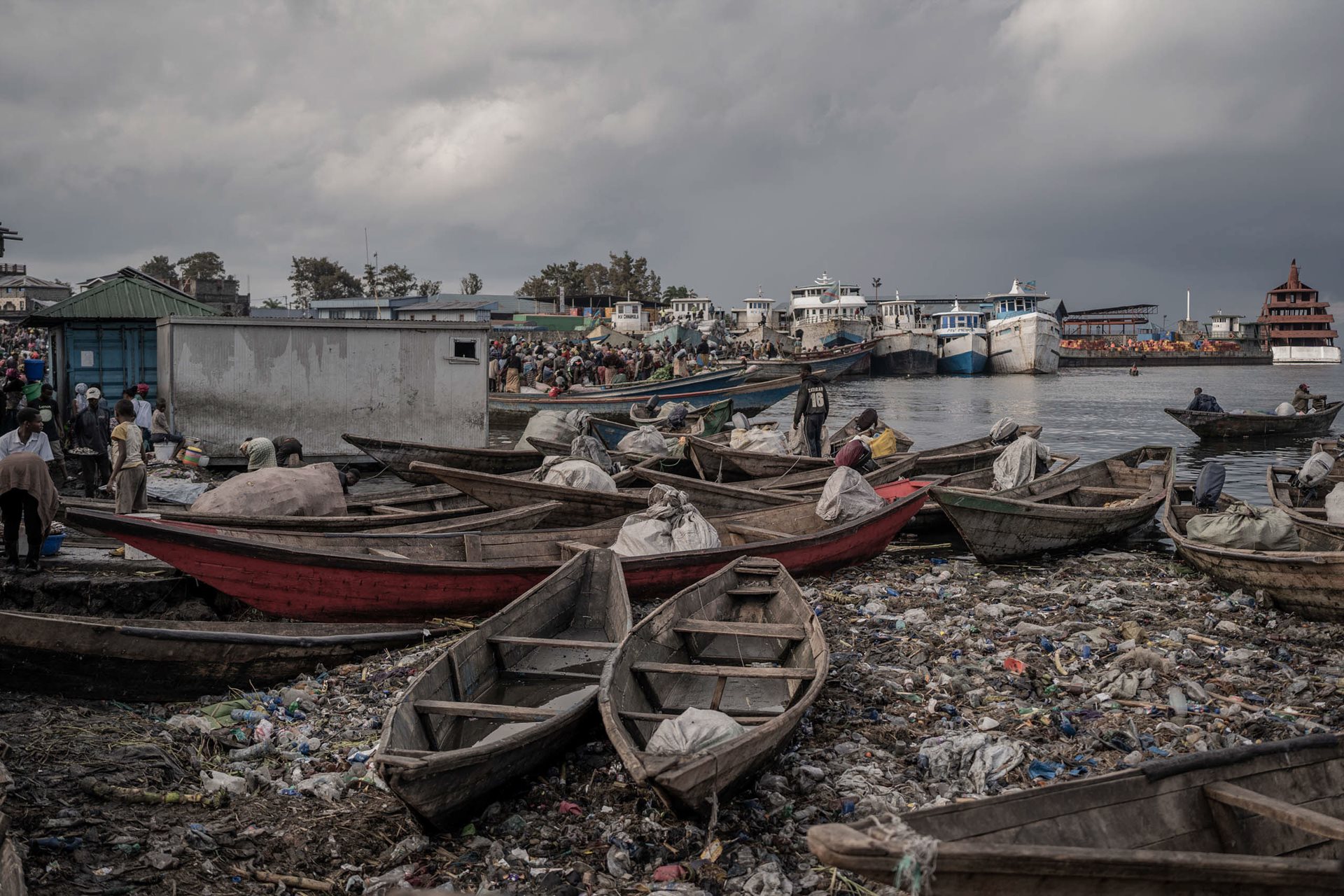 Canoes sit atop piles of plastic waste at the port of Kituku, in Goma, DRC.