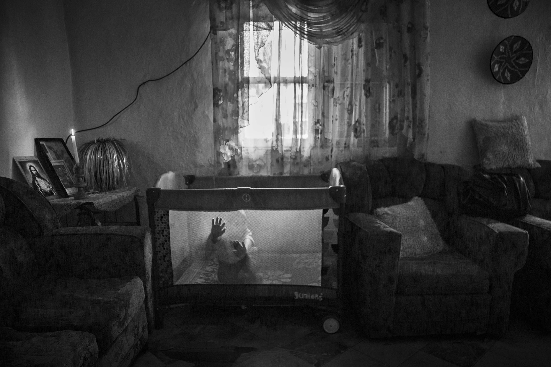 An Eritrean baby in the living room his parents share with other refugee families in Addis Ababa, Ethiopia. Conditions are harsh for refugee children, as they spend many hours alone while their parents are out trying to make a living in a foreign country. &quot;I want my son to be free one day. Free to choose his own future, like your children,&quot; says Mesele&#39;s father.