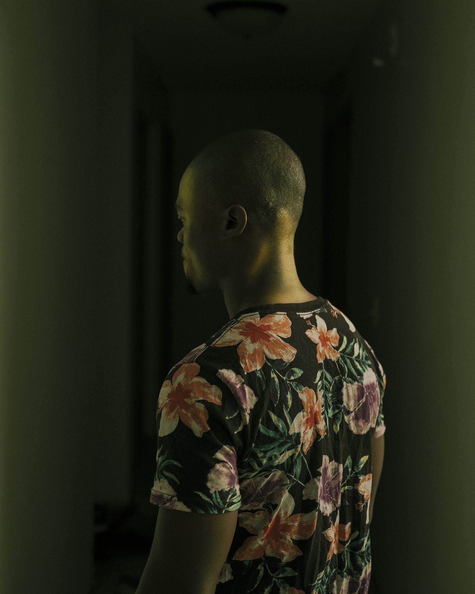 An anonymous employee of a Sioux Falls meatpacking plant stands for a portrait at his apartment in Sioux Falls, South Dakota, USA. Originally from Eritrea, he moved from a meatpacking plant in Iowa to work in South Dakota. Although he does not like the job, he says he has no other options.