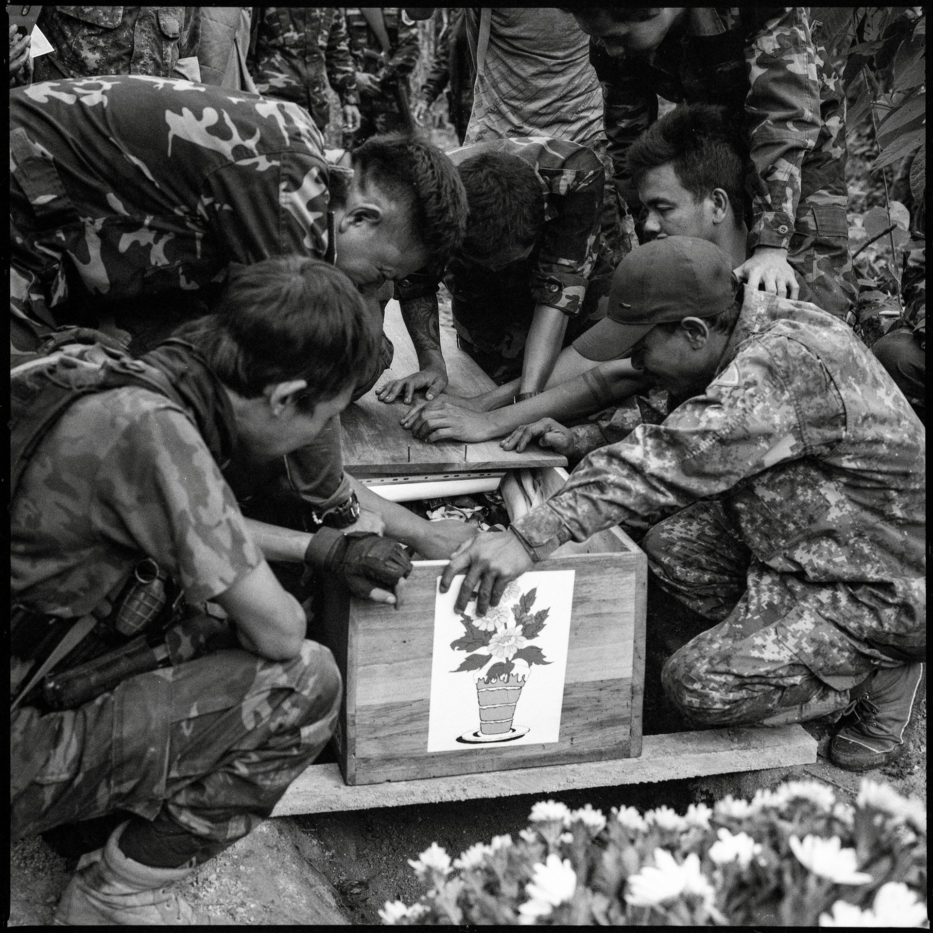 Naypyitaw People&#39;s Defense Force (PDF) fighters grieve during the funeral of their comrade, Zayya Kyaw, in an area controlled by a coalition of resistance forces, in Kayah (Karenni) State, Myanmar. Zayya Kyaw (25) was killed two days earlier during a battle in Yado village, nearby.