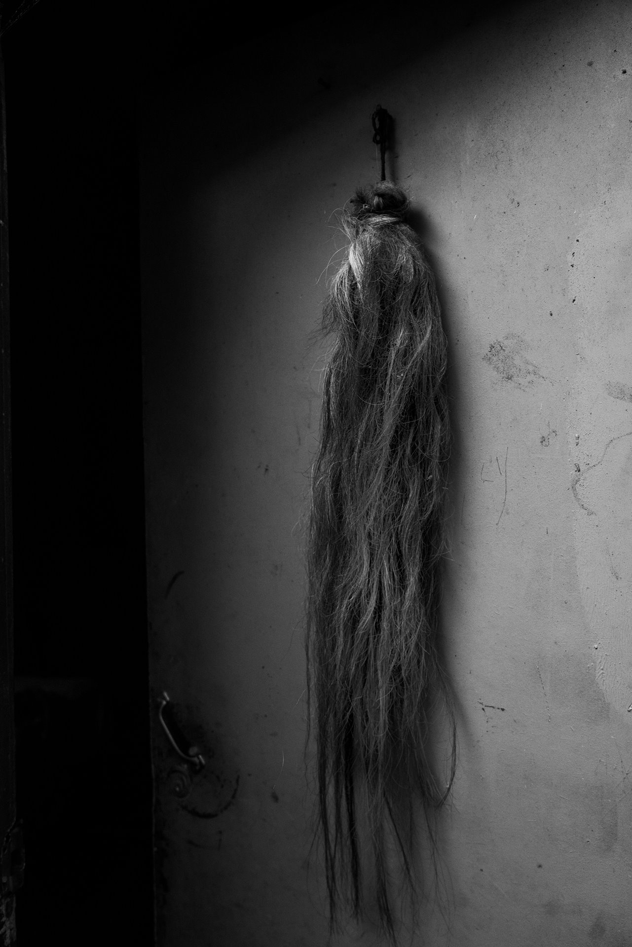 A horse tail hangs on the door of a house in the Huañaco Millao community, in Araucania, Chile. Many Mapuche see the horse as a powerful animal and use tail hair in medicine, and to drive away bad energy.&nbsp;