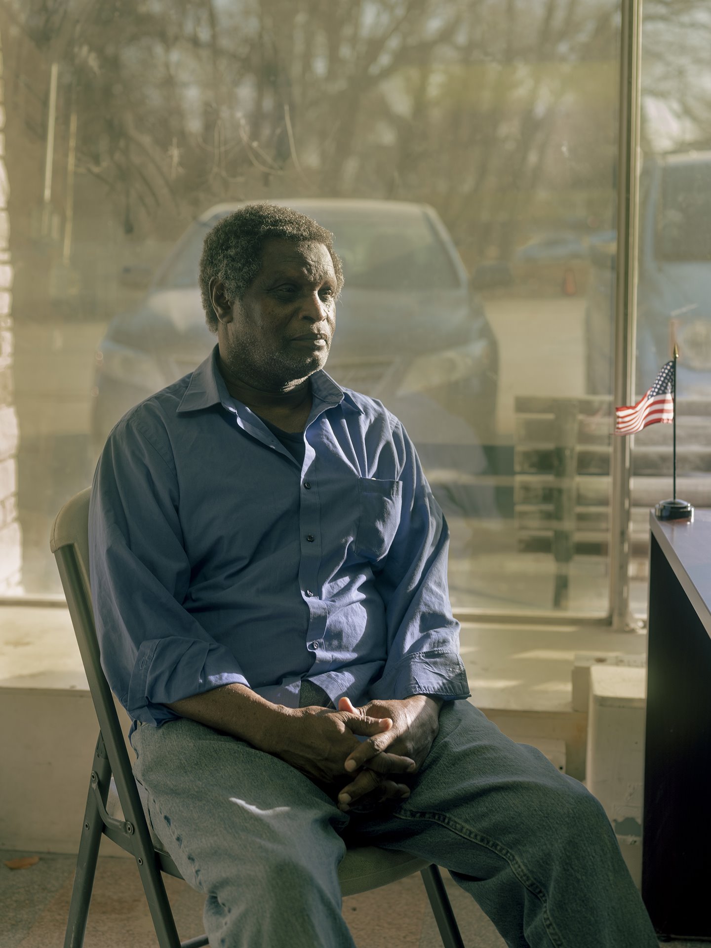 Heussein Hirsu, sits ready for a meeting at the East African Development Association of Nebraska, in Omaha, Nebraska. Originally from Somalia, he came to the US from a refugee camp in Kenya, and &nbsp;works in a meat processing plant.