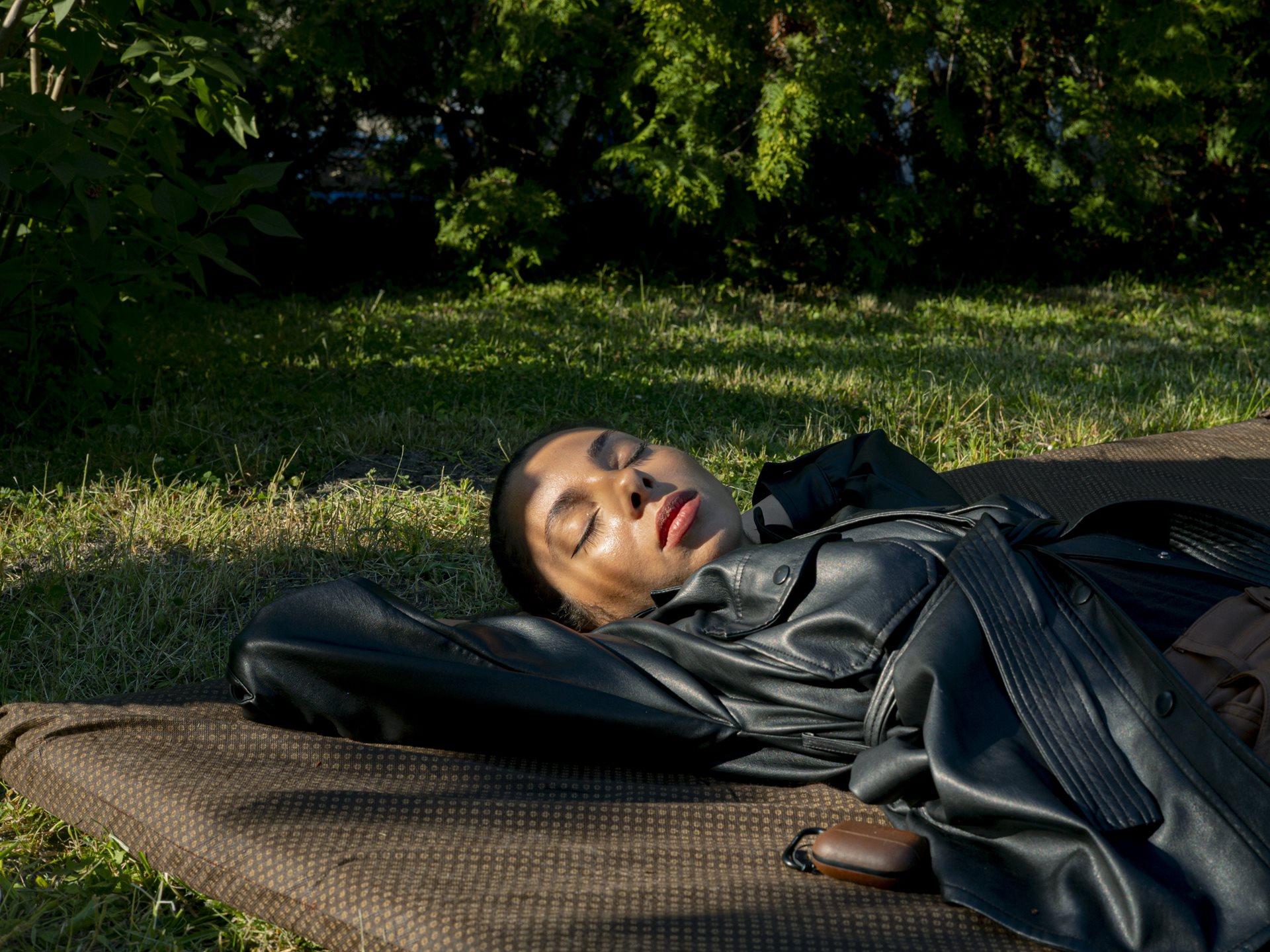 <p>Lobna, of Moroccan and Egyptian descent, rests in a garden during a gathering with friends. She studied advertising and now works for an agency. Aulnay-sous-Bois, France</p>
