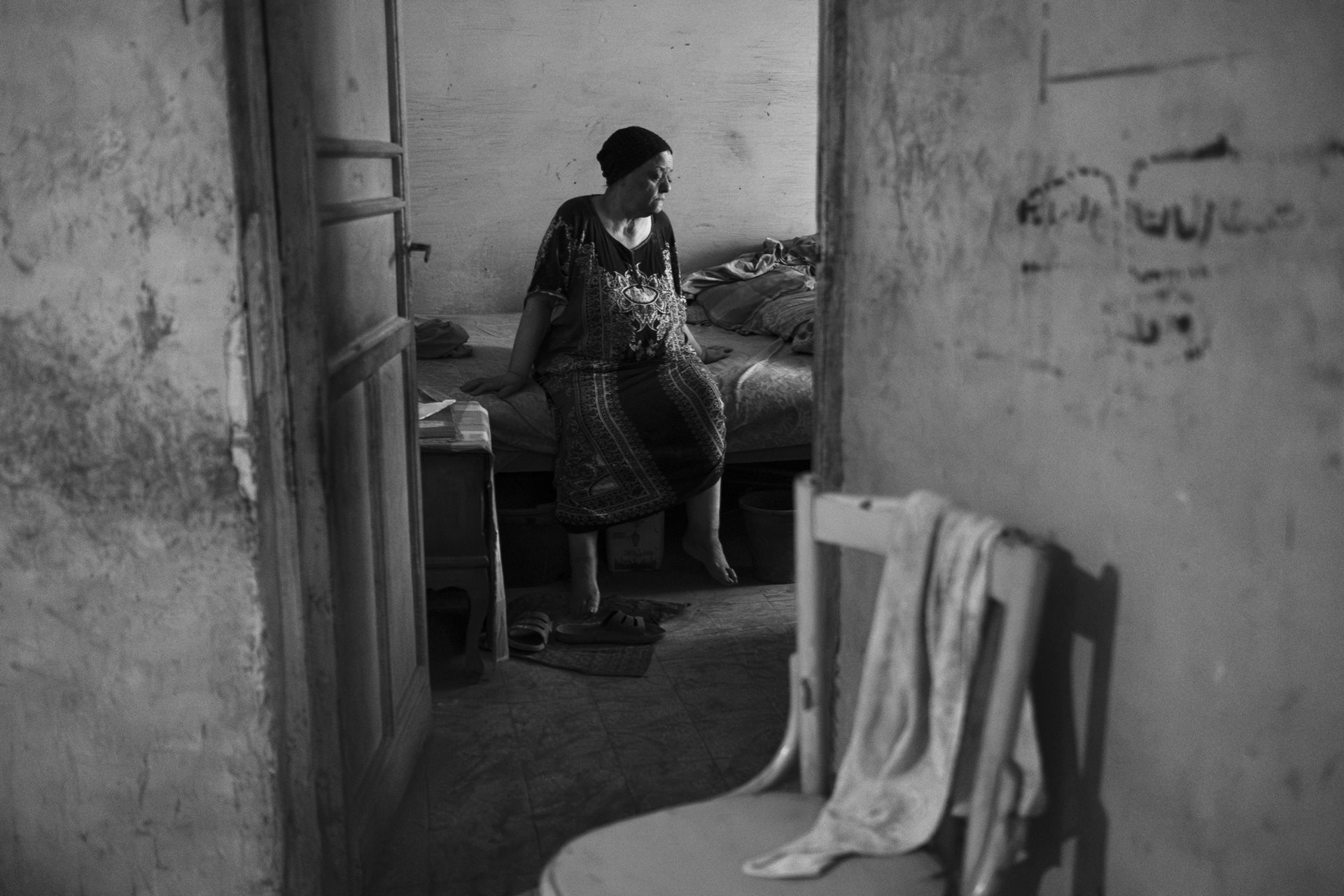 Kadry's mother in her home in Moon Valley, Alexandria, Egypt. She suffered from asthma and lung disease before passing away in 2023. Dust covers every surface.&nbsp;<br />
&nbsp;
