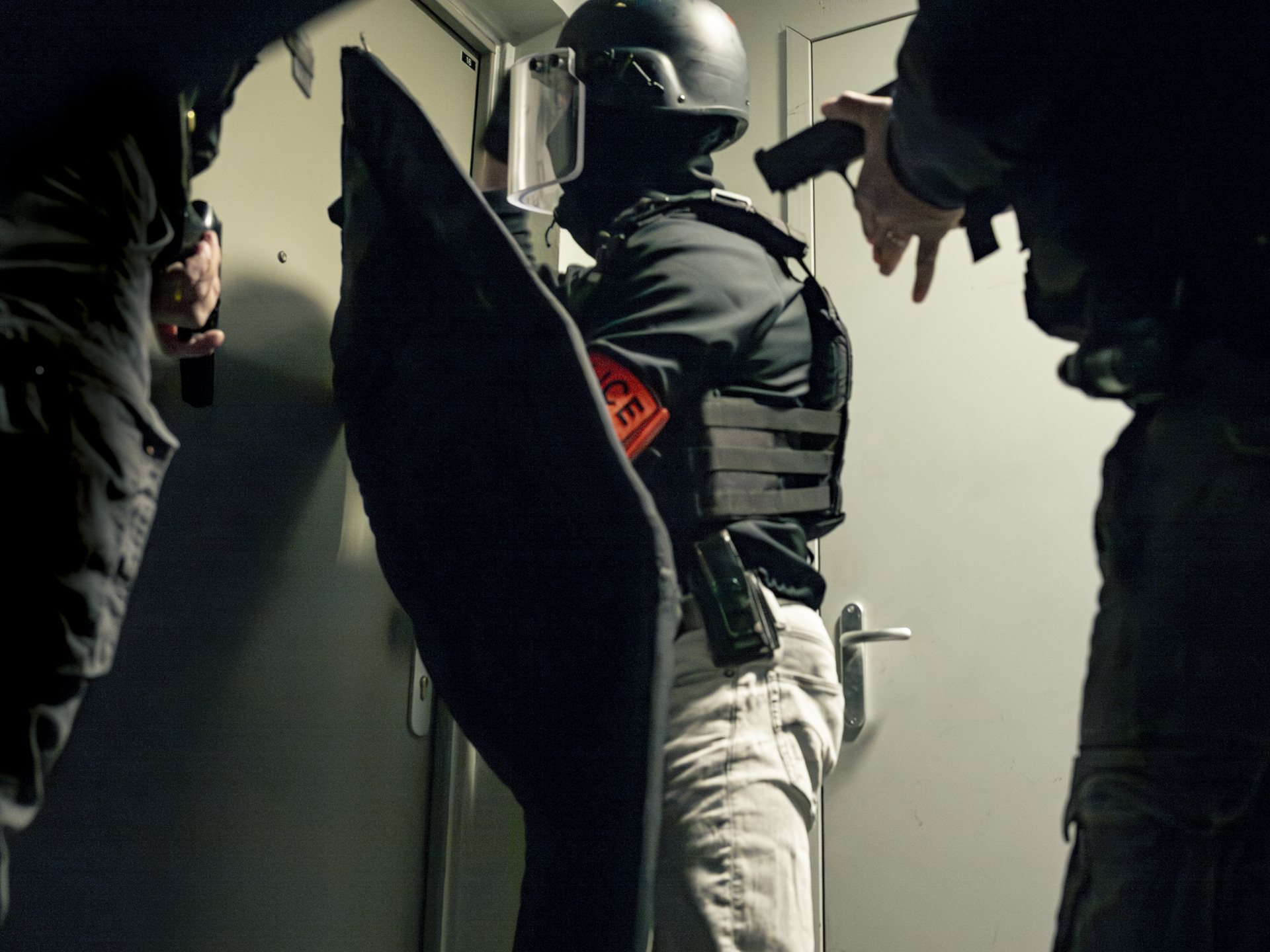 Officers of the anti-crime brigade (BAC) prepare to raid a suspected drug dealer's home at 6 a.m. in Seine-Saint-Denis, France.