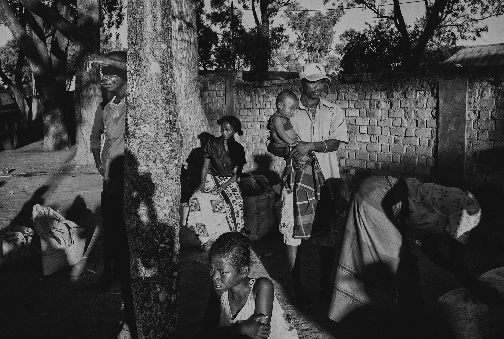 <p>People wait to receive oil and rice from the Malagasy Red Cross, in Amboasary Sud, Madagascar. Around 1,200 people have been displaced from the nearby village of Andranondambo, which had been completely destroyed by dahalo cattle-raiders.</p>
