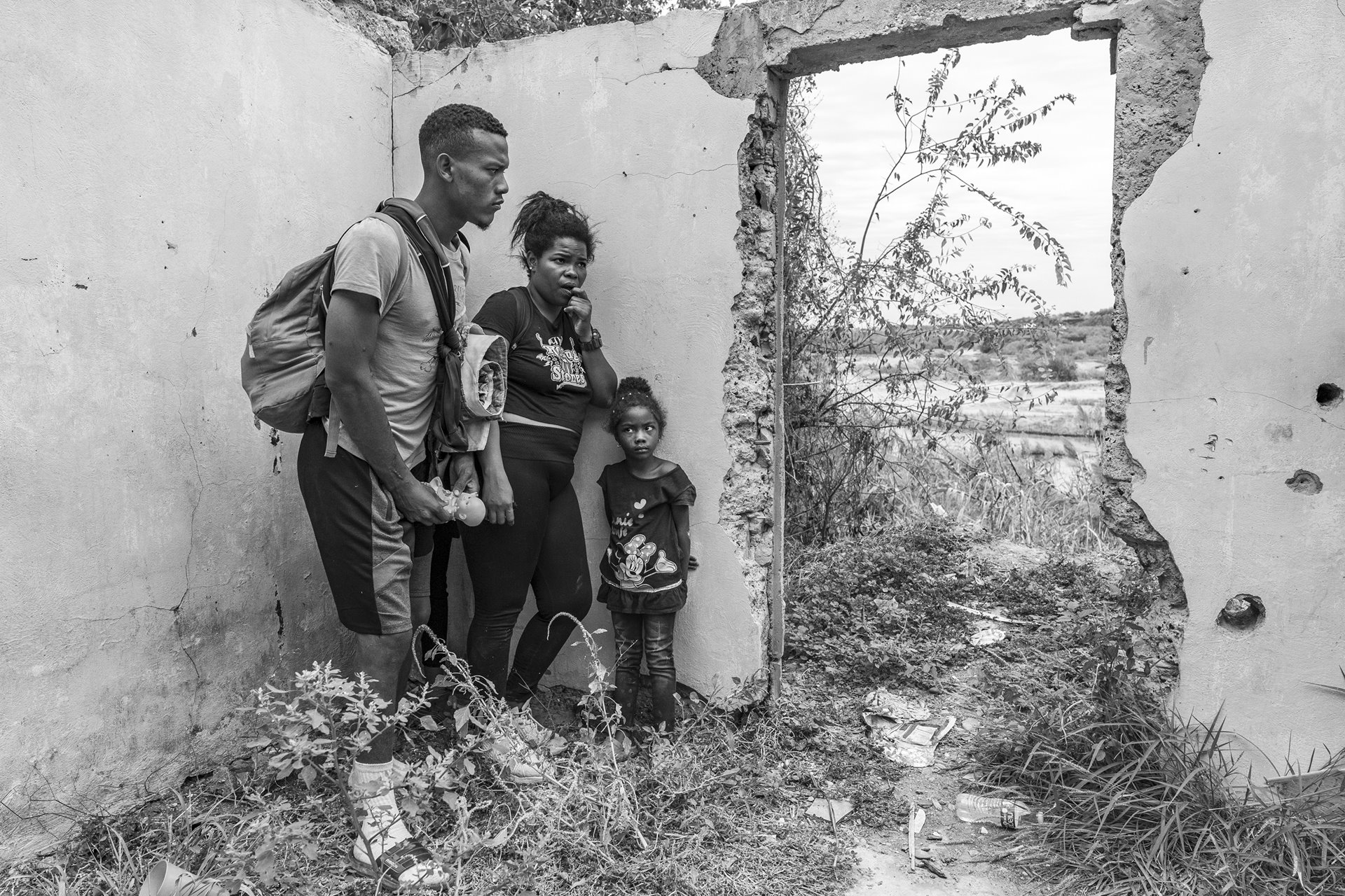Eddie, Carolina, and their four-year-old daughter, Valentina, hide inside an abandoned house in the final stretch of land before the Mexican-US border, in Piedras Negras, Mexico. Mexican authorities patrol the area to stop migrants from crossing the Rio Bravo.&nbsp;