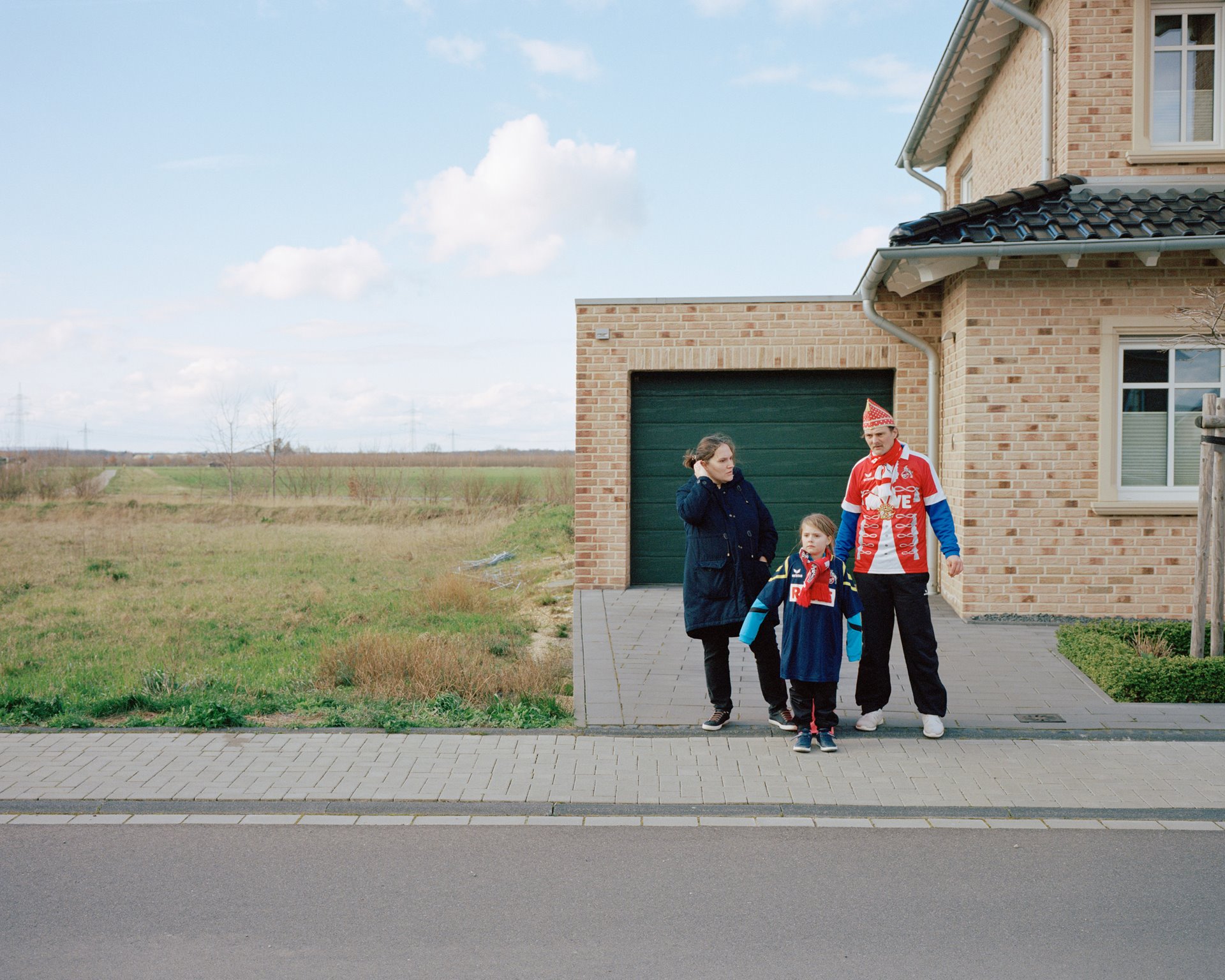 Residents of the Manheim-neu resettlement site wait for the passing Carnival procession. Their former village of Manheim, more than a thousand years old and just a few kilometers away, was demolished to make way for expansion of the Hambach mine, which reached the village limits in 2022.