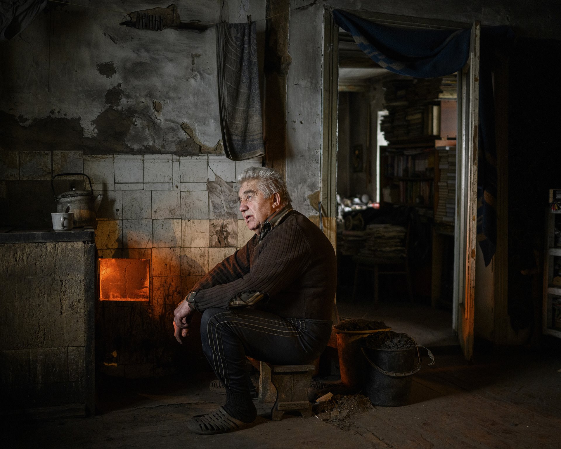 Alexander Ivanovich sits in his home, in Avdiivka, Donbas, Ukraine, a few hundred meters from the front line of the conflict between Ukrainian and separatist forces. His home had been hit by shells five times.