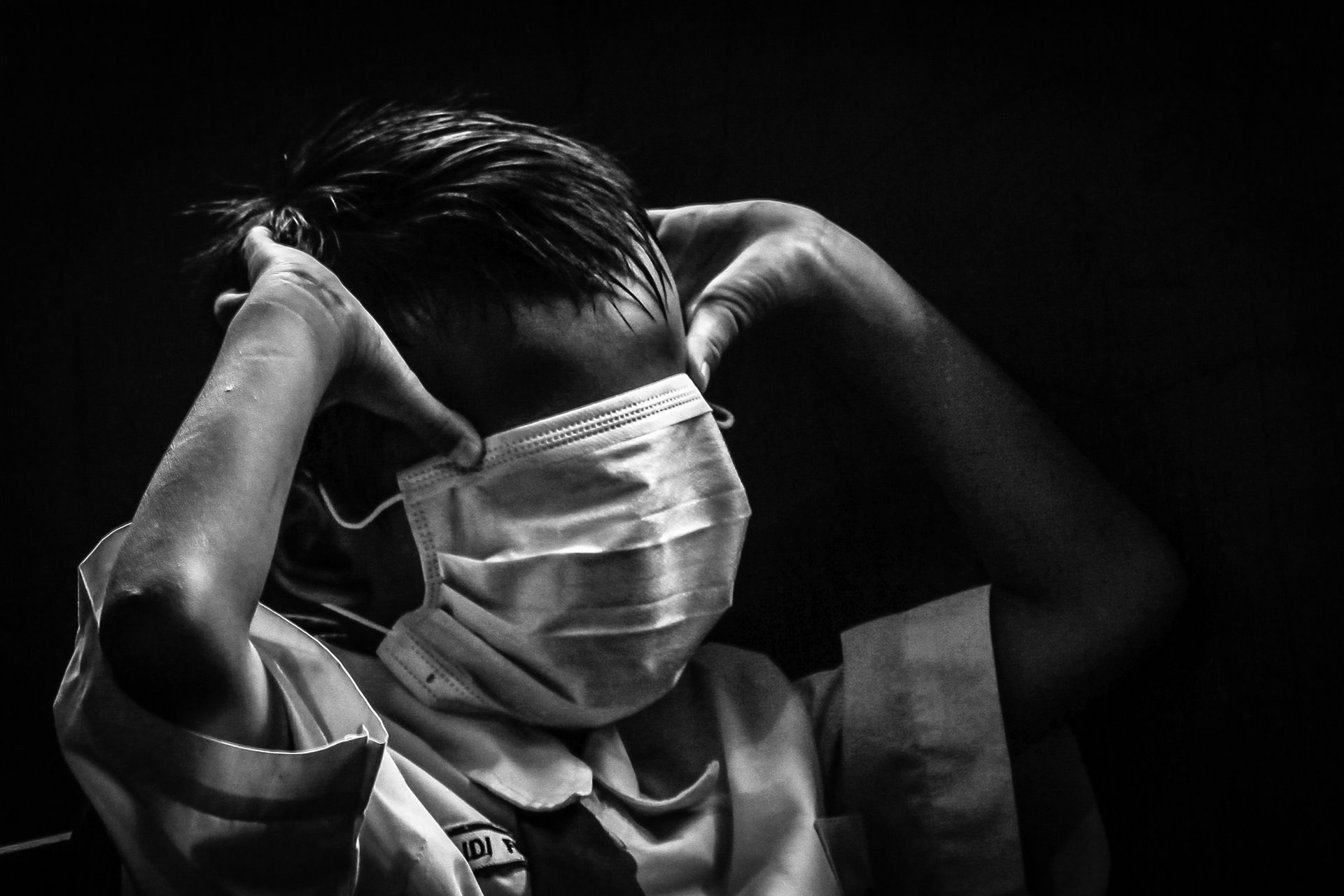 A child in a classroom in Palembang, South Sumatra, Indonesia, covers his face with a mask to avoid the smell of smoke from a forest fire.