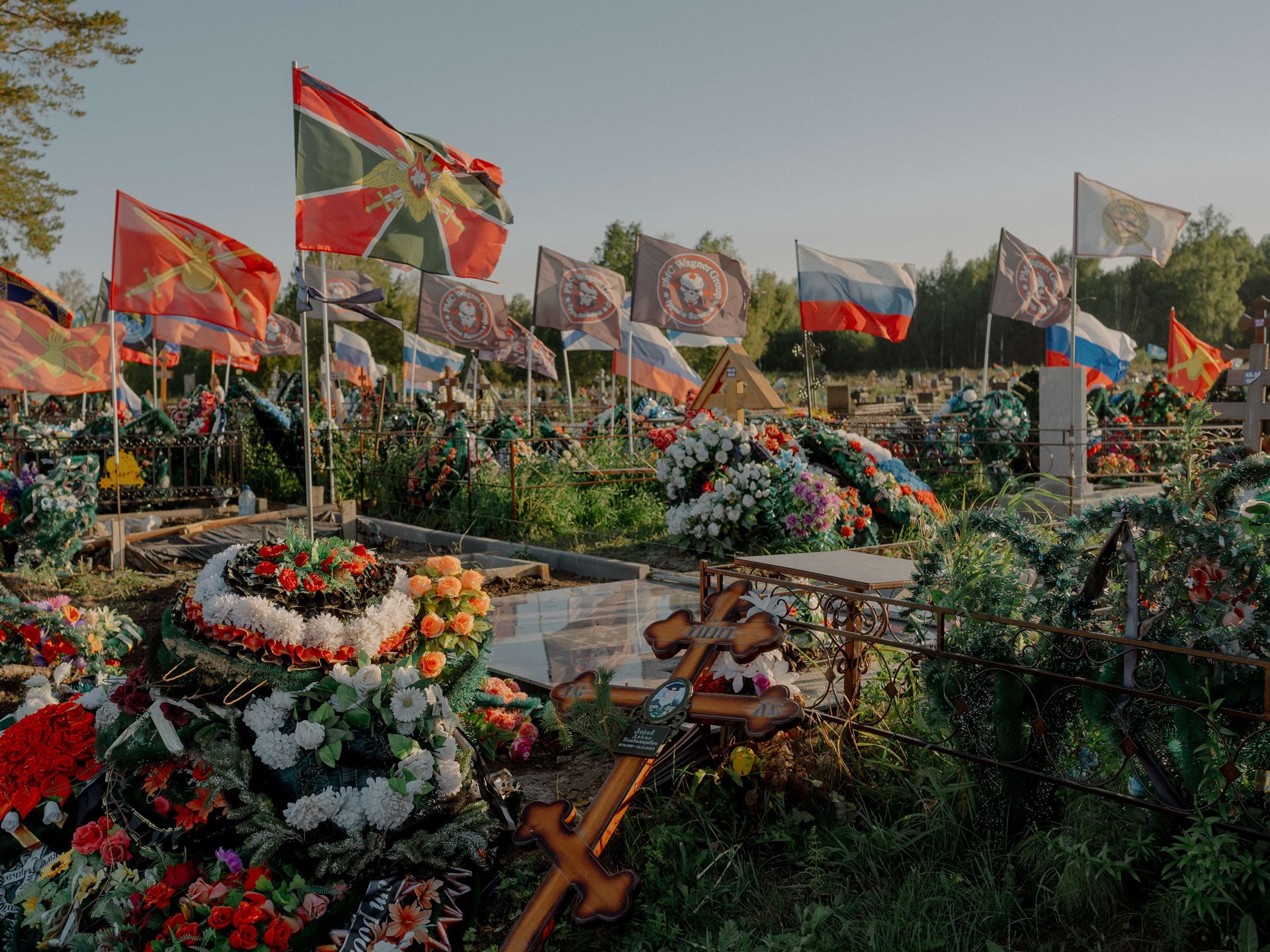 Russian flags and those of various units of the Russian defence forces and Wagner Group fly over the graves of soldiers killed in Ukraine, at a cemetery in Tomsk, Russia.
