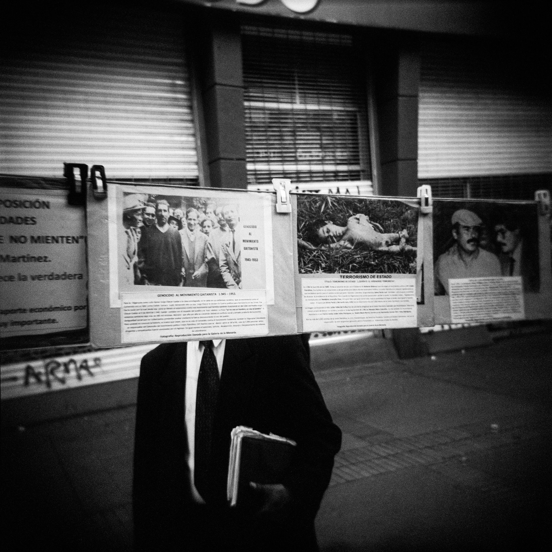A passer-by looks at photos relating to Colombia&rsquo;s internal conflict, in a street exhibition in Bogotá. In the years leading up to 2013, the conflict had resulted in around 220,000 deaths, 80 percent of which were civilians, according to the Historical Memory Group (GMH). Millions of Colombians &ndash; some 15 percent of the population &ndash; had been displaced.