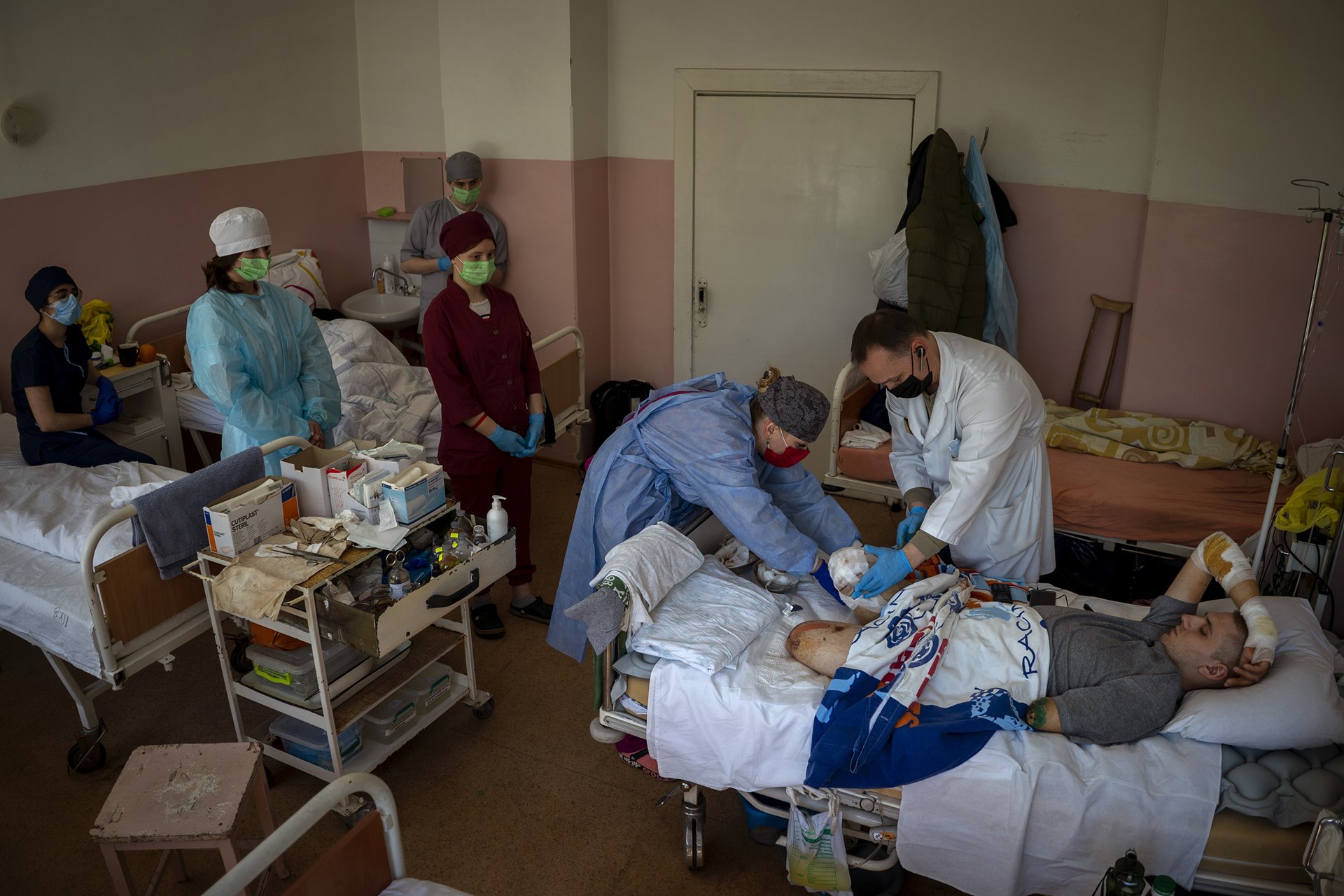 Anton Gladun (22) has his wounds cleaned by hospital doctors, in Cherkasy, Ukraine. Anton, a military medic deployed on the front line in eastern Ukraine, lost both legs and the left arm in an explosion on 27 March.