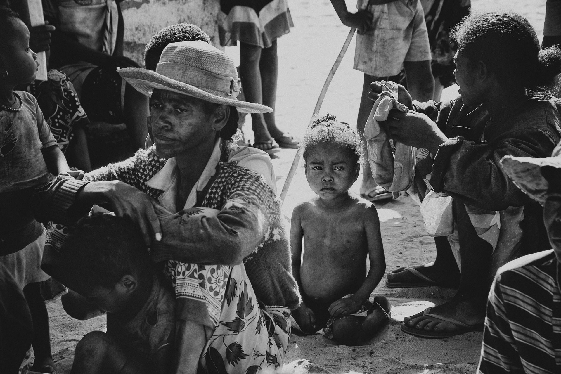 People wait to be seen by medical personnel from a Médecins Sans Frontières (MSF) mobile clinic, in Marovato, Madagascar. Since June 2021, MSF has operated such clinics in the region to treat malnutrition to help combat a food crisis brought on by decades of intense drought.