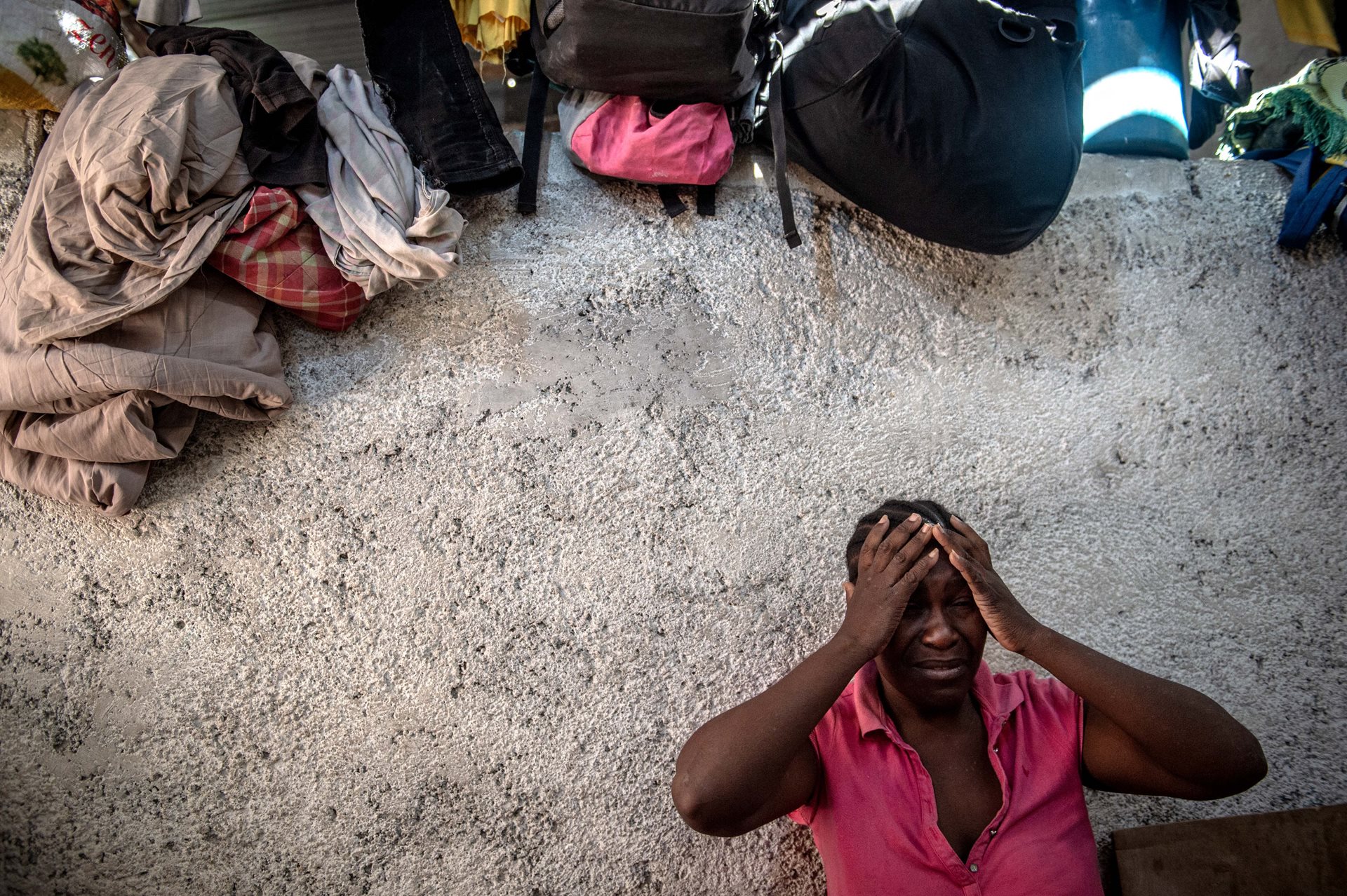 A woman fleeing gang violence in her neighborhood takes refuge in the Frere Jean-Baptiste college in Port-au-Prince, Haiti.