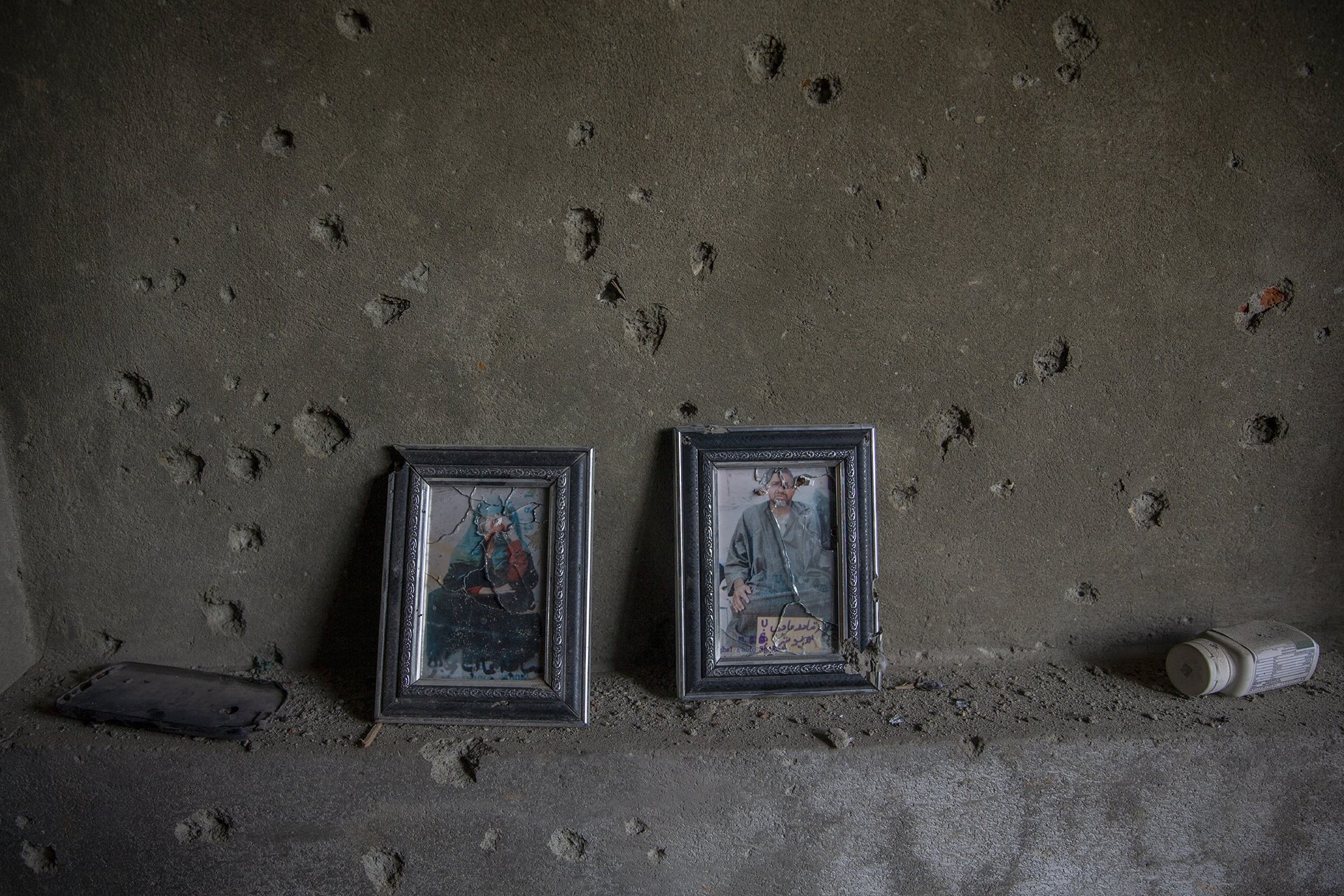 Photographs of Kashmiri Sufi saints are seen on the bullet-ridden wall of a house damaged in a gunfight in Srinagar, in India-administered Kashmir. Officials said two suspected militants were killed in the shoot-out.